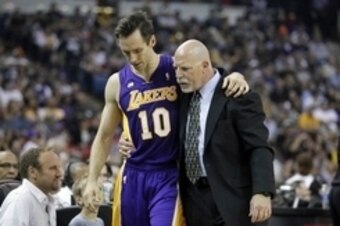 Mar 30, 2013; Sacramento, CA, USA; Los Angeles Lakers guard Steve Nash (10) talks with athletic trainer Gary Vitti after leaving the game against the Sacramento Kings in the first quarter at Sleep Train Arena. Mandatory Credit: Cary Edmondson-USA TODAY Sp