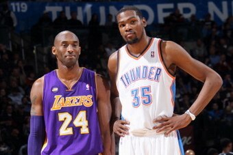 OKLAHOMA CITY, OK - March 05:  Kobe Bryant #24 of the Los Angeles Lakers and Kevin Durant #35 of the Oklahoma City Thunder stand on the court during the game on March 05, 2013 at the Chesapeake Energy Arena in Oklahoma City, Oklahoma. NOTE TO USER: User e