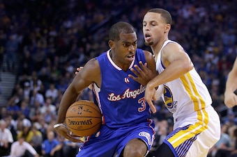 OAKLAND, CA - NOVEMBER 05:  Chris Paul #3 of the Los Angeles Clippers drives on Stephen Curry #30 of the Golden State Warriors at ORACLE Arena on November 5, 2014 in Oakland, California. NOTE TO USER: User expressly acknowledges and agrees that, by downlo
