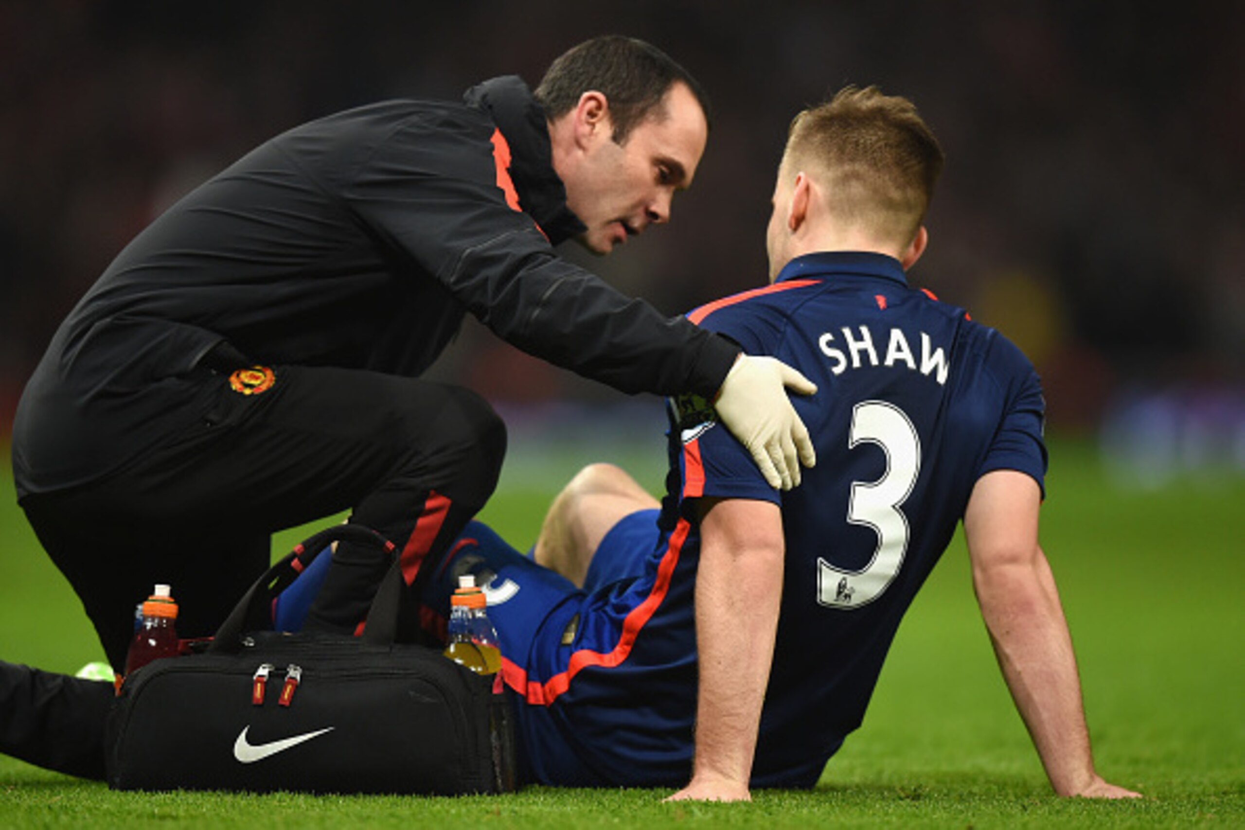 LONDON, ENGLAND - NOVEMBER 22:  Luke Shaw of Manchester United receives treatment during the Barclays Premier League match between Arsenal and Manchester United at Emirates Stadium on November 22, 2014 in London, England.  (Photo by Michael Regan/Getty Im