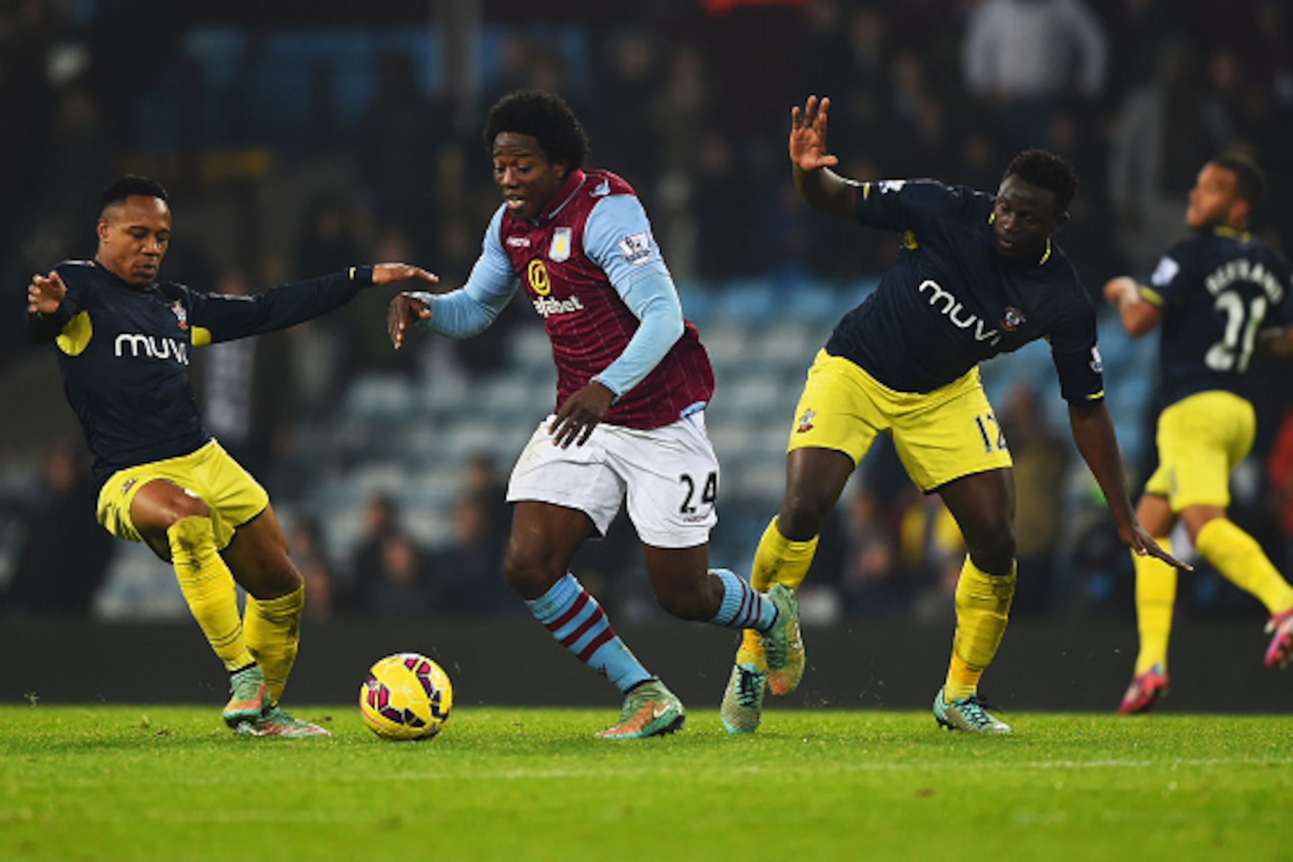 BIRMINGHAM, ENGLAND - NOVEMBER 24:  Carlos Sanchez of Aston Villa goes between Nathaniel Clyne (L) and Victor Wanyama of Southampton (12) during the Barclays Premier League match between Aston Villa and Southampton at Villa Park on November 24, 2014 in Bi