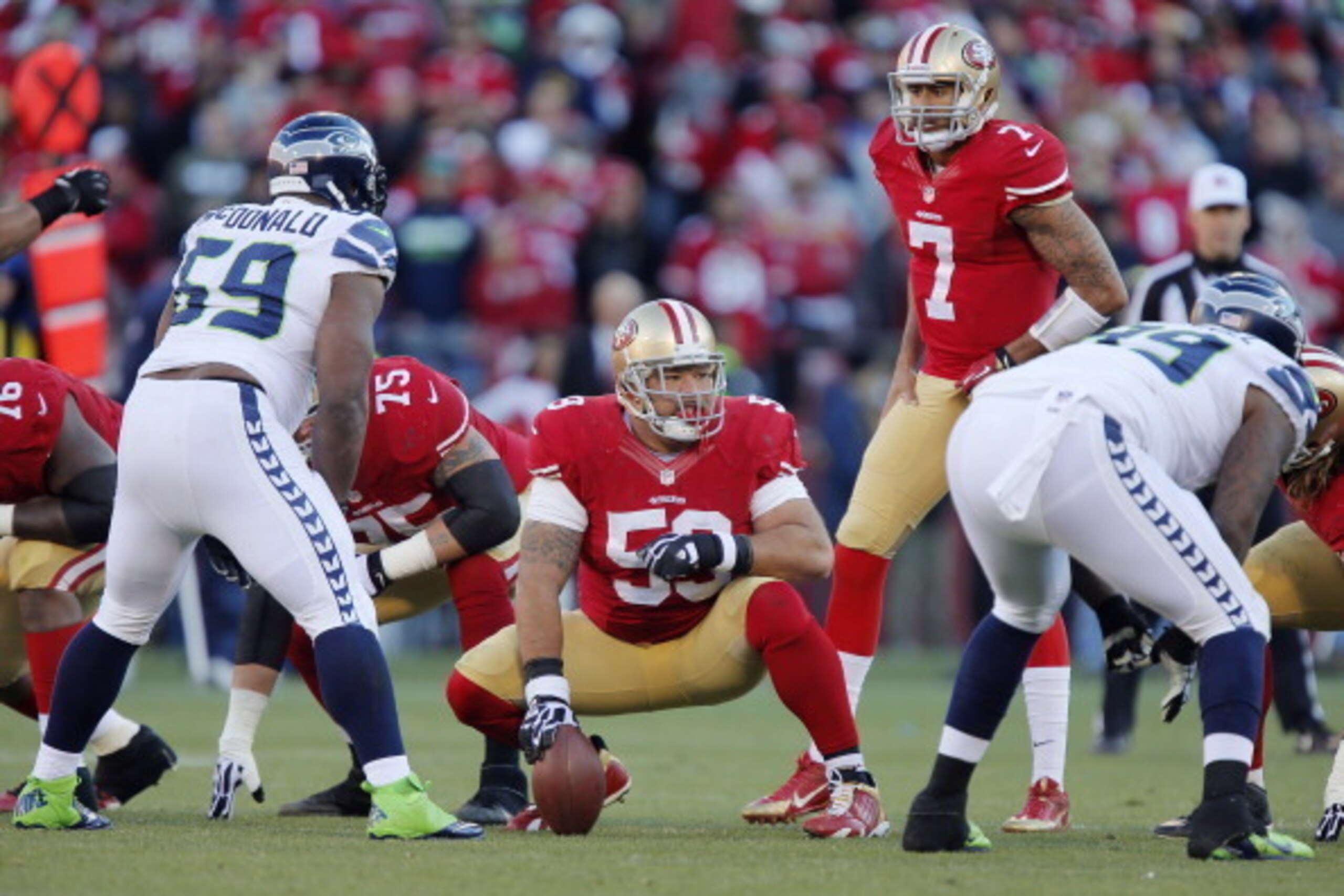 SAN FRANCISCO, CA - DECEMBER 08:  Center Jonathan Goodwin #59 of the San Francisco 49ers looks down the line as quarterback Colin Kaepernick #7 calls out the snap count against the Seattle Seahawks in the third quarter on December 8, 2013 at Candlestick P