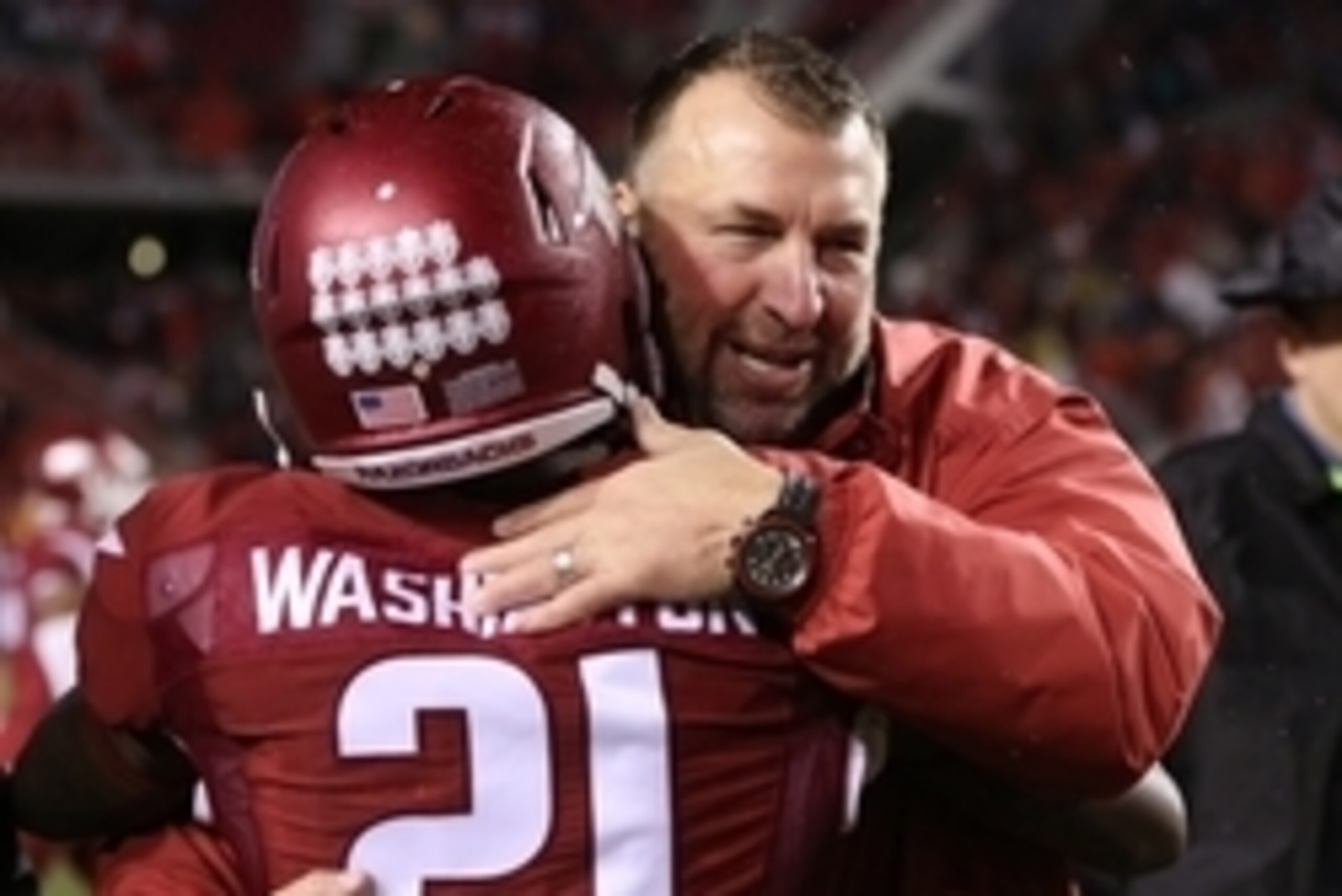 Nov 22, 2014; Fayetteville, AR, USA; Arkansas Razorbacks head coach Bret Bielema celebrates with cornerback Carroll Washington (21) after the game against the Ole Miss Rebels at Donald W. Reynolds Razorback Stadium. Arkansas defeated Mississippi 30-0. Man