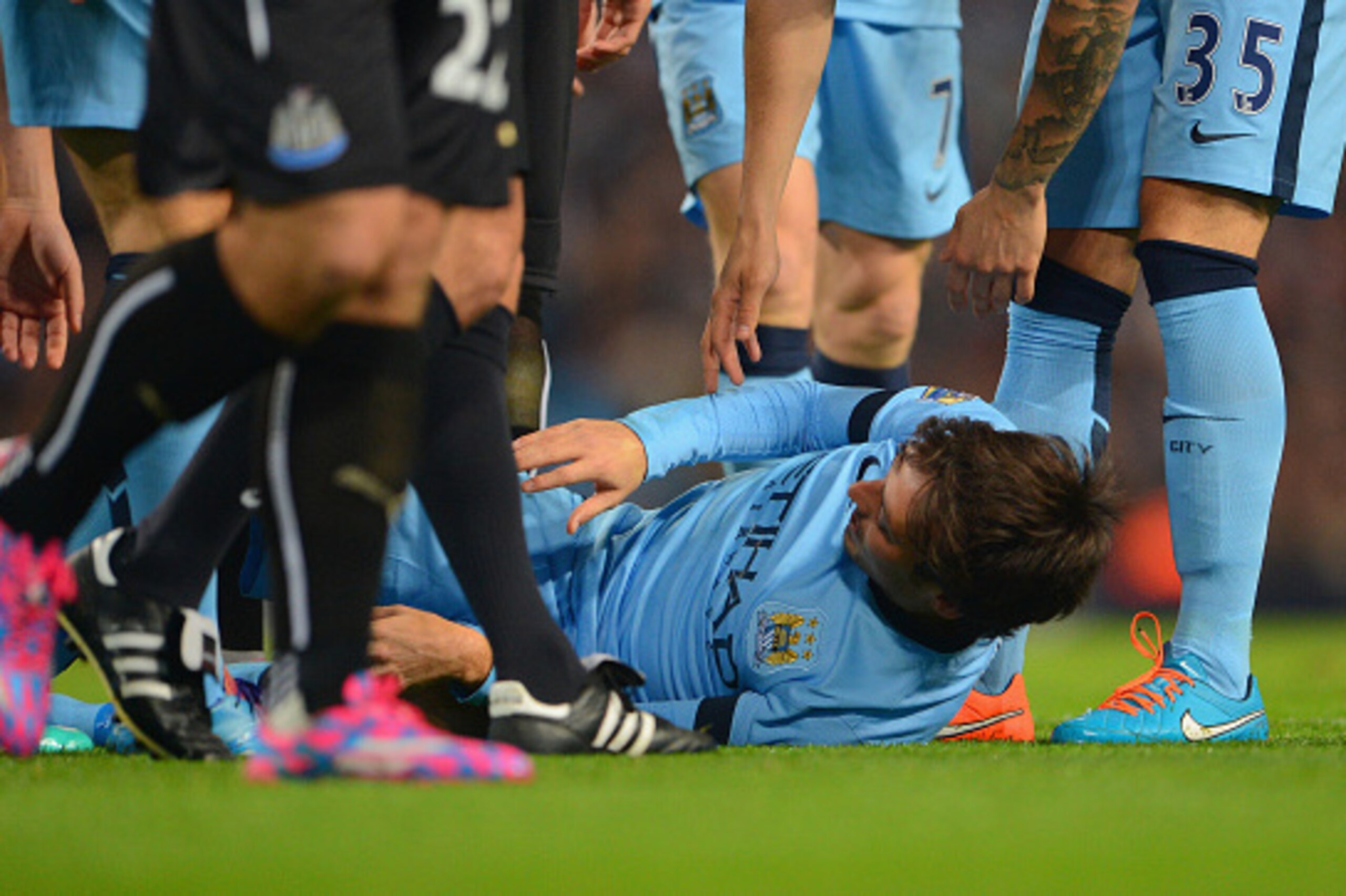MANCHESTER, ENGLAND - OCTOBER 29:   David Silva of Manchester City after he lies injured after a tackle from Ryan Taylor of Newcastle United during the Capital One Cup Fourth Round match between Manchester City and Newcastle United at Etihad Stadium on Oc