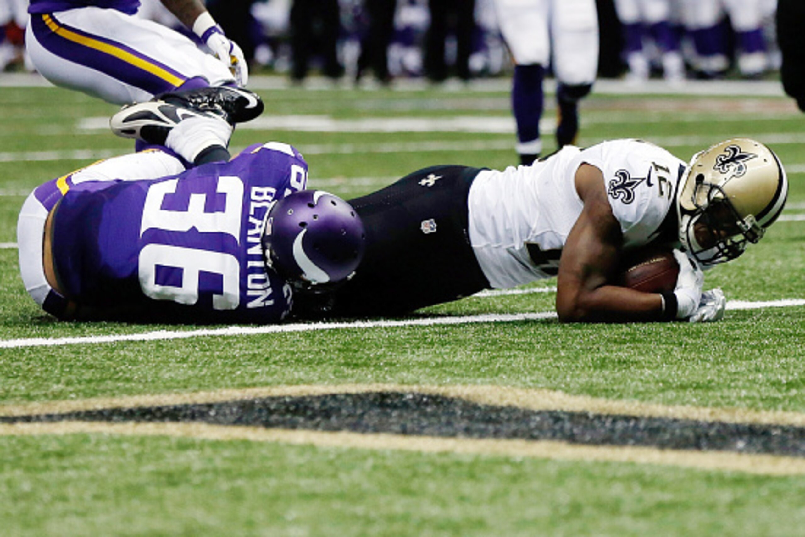 NEW ORLEANS, LA - SEPTEMBER 21:  Marques Colston #12 of the New Orleans Saints scores a touchdown over Robert Blanton #36 of the Minnesota Vikings during the fourth quarter of a game at the Mercedes-Benz Superdome on September 21, 2014 in New Orleans, Lou