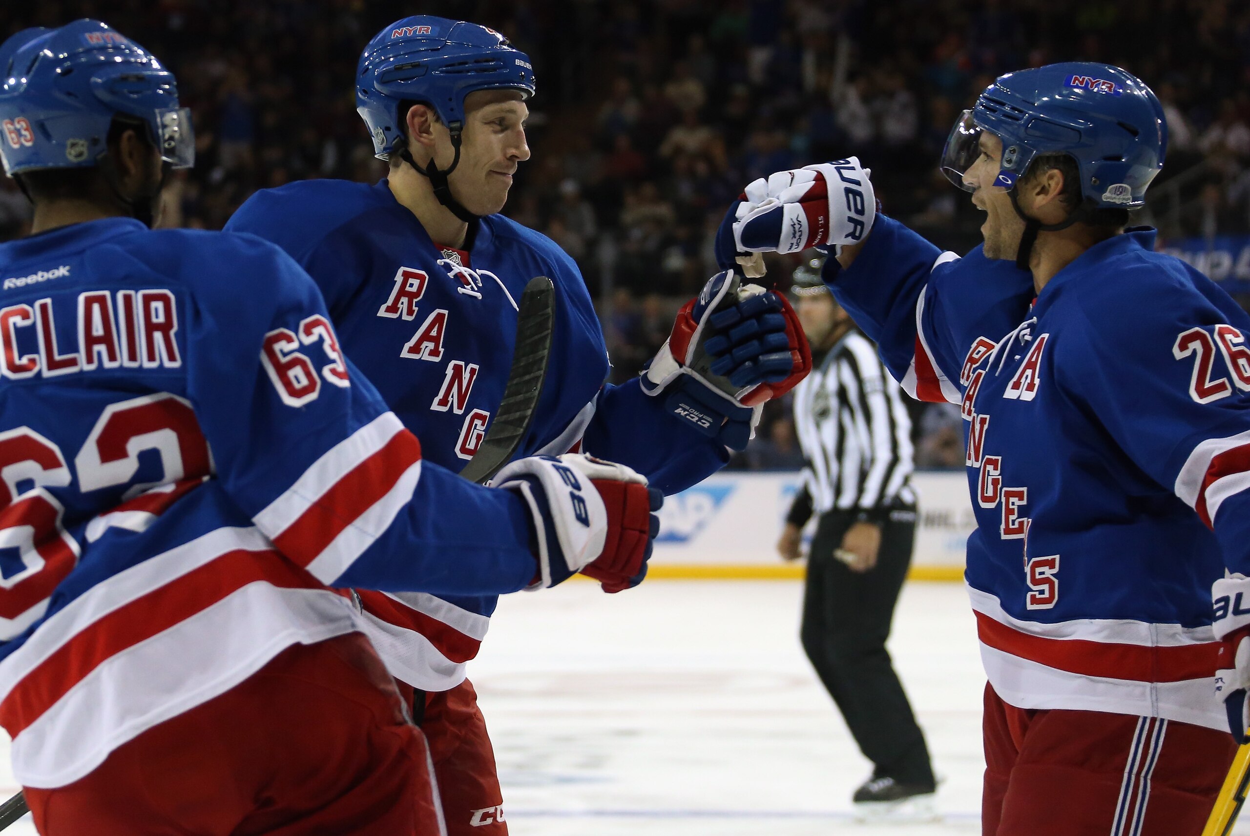 NEW YORK, NY - OCTOBER 03: Matt Hunwick #44 of the New York Rangers (C) celebrates his second period goal against the Chicago Blackhawks along with Anthony Duclair #63 (L) and Martin St. Louis #26 (R) at Madison Square Garden on October 3, 2014 in New Yor NEW YORK, NY - OCTOBER 03: Matt Hunwick #44 of the New York Rangers (C) celebrates his second period goal against the Chicago Blackhawks along with Anthony Duclair #63 (L) and Martin St. Louis #26 (R) at Madison Square Garden on October 3, 2014 in New Yor