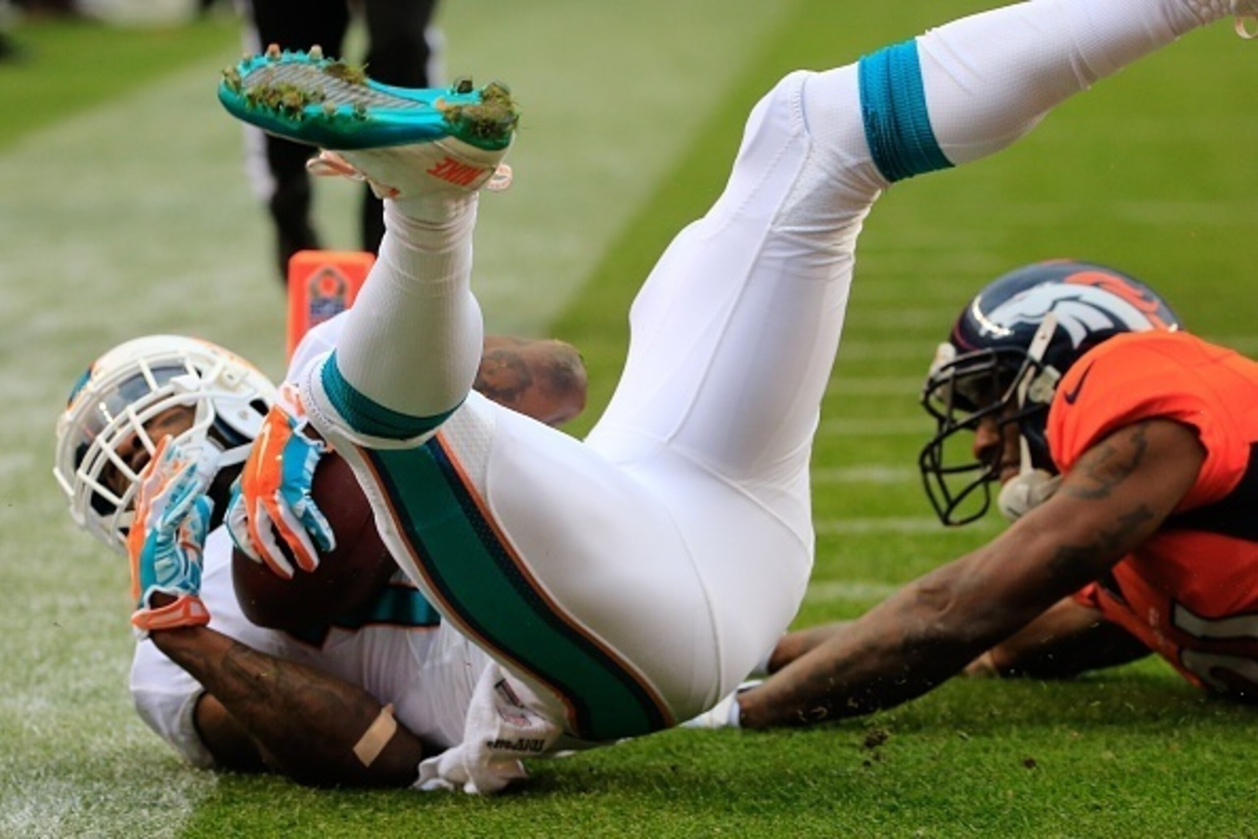 DENVER, CO - NOVEMBER 23:  Wide receiver Mike Wallace #11 of the Miami Dolphins has a second quarter touchdown reception against the Denver Broncos during a game at Sports Authority Field at Mile High on November 23, 2014 in Denver, Colorado.  (Photo by D