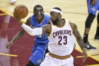 Nov 24, 2014; Cleveland, OH, USA; Cleveland Cavaliers forward LeBron James (23) catches a pass while defended by Orlando Magic guard Victor Oladipo (5) in the first quarter at Quicken Loans Arena. Mandatory Credit: David Richard-USA TODAY Sports