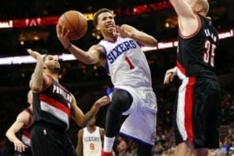 Nov 24, 2014; Philadelphia, PA, USA; Philadelphia 76ers guard Michael Carter-Williams (1) goes up for a shot past Portland Trail Blazers center Chris Kaman (35) during the second half at the Wells Fargo Center. The Trail Blazers defeated the 76ers 114-104