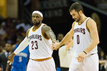 CLEVELAND, OH - NOVEMBER 24: LeBron James #23 celebrates with Kevin Love #0 of the Cleveland Cavaliers during the first half against the Orlando Magic at Quicken Loans Arena on November 24, 2014 in Cleveland, Ohio. NOTE TO USER: User expressly acknowledge