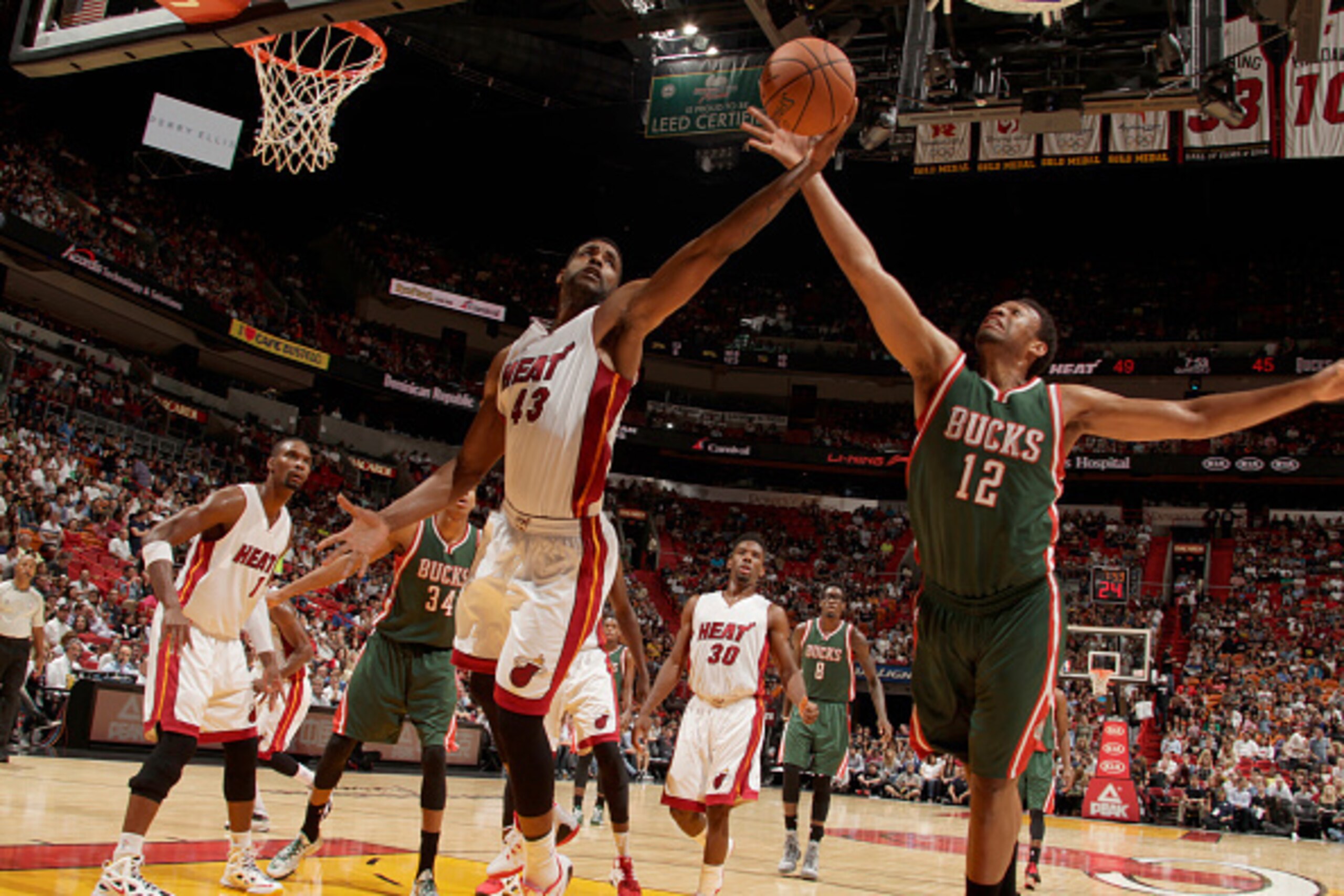 MIAMI, FL - NOVEMBER 16:  Shawne Williams #43 of the Miami Heat and Jabari Parker #12 of the Milwaukee Bucks go after a rebound during the game on November 16, 2014 at AmericanAirlines Arena in Miami, Florida. NOTE TO USER: User expressly acknowledges and