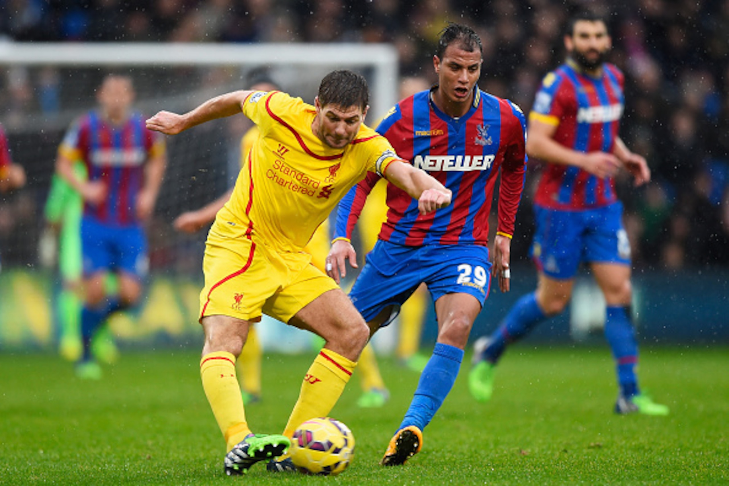 LONDON, ENGLAND - NOVEMBER 23: Steven Gerrard of Liverpool is closed down by Marouane Chamakh of Crystal Palace during the Barclays Premier League match between Crystal Palace and Liverpool at Selhurst Park on November 23, 2014 in London, England.  (Photo