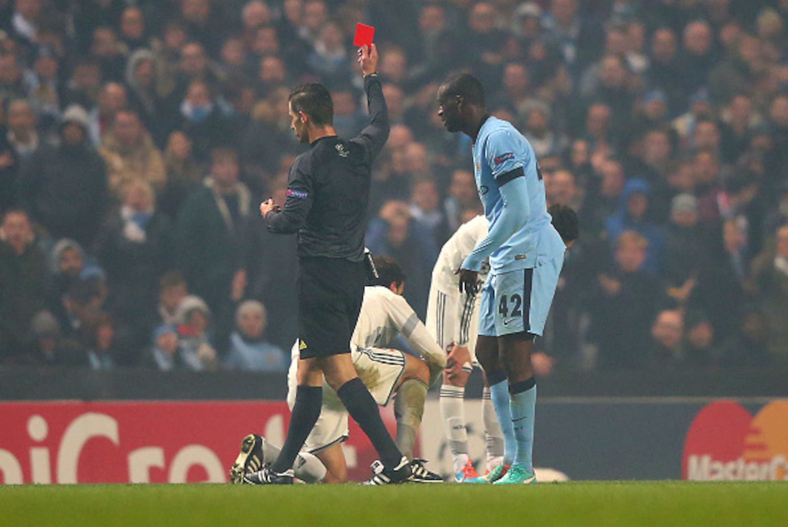 MANCHESTER, ENGLAND - NOVEMBER 05:  Yaya Toure of Manchester City is shown a red card by Referee Tasos Sidriopoulos during the UEFA Champions League Group E match between Manchester City and CSKA Moscow on November 5, 2014 in Manchester, United Kingdom.  