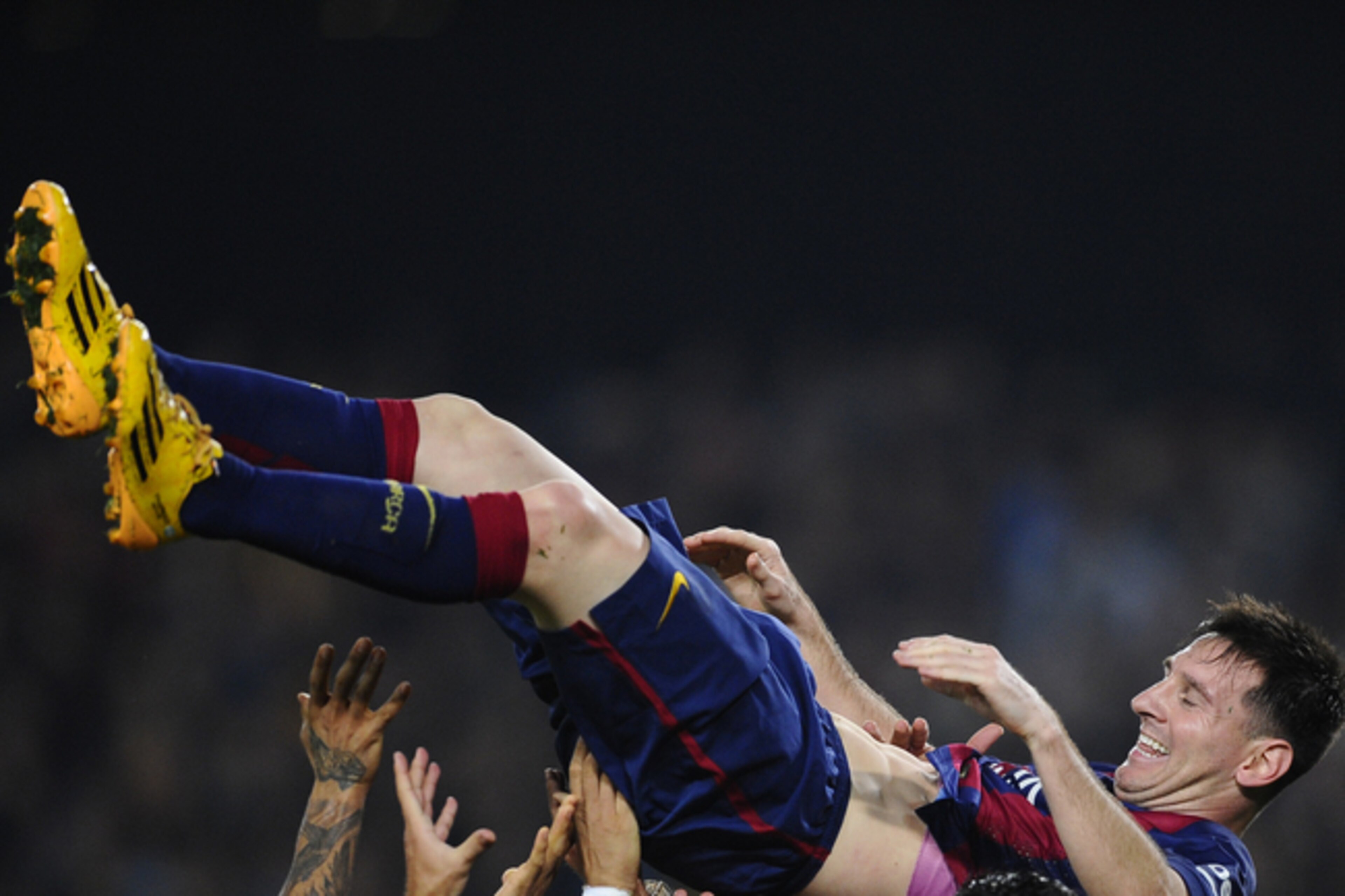 Hail to the king—Lionel Messi is lifted by team-mates following his La Liga hat-trick against Sevilla on Saturday