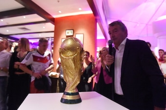 RIO DE JANEIRO, BRAZIL - JULY 13:  DFB president Wolfgang Niersbach speaks in front of the World Cup trophy as the Germany team celebrate at a party, after winning the 2014 FIFA World Cup Brazil Final match against Argentina, at Sheraton Hotel on July 13,