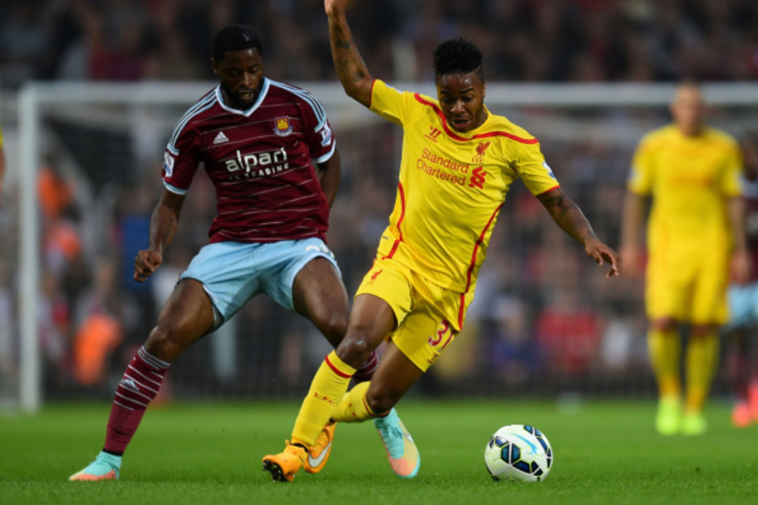 LONDON, ENGLAND - SEPTEMBER 20:  Raheem Sterling of Liverpool is challenged by Alexandre Song of West Ham during the Barclays Premier League match between West Ham United and Liverpool at Boleyn Ground on September 20, 2014 in London, England.  (Photo by 