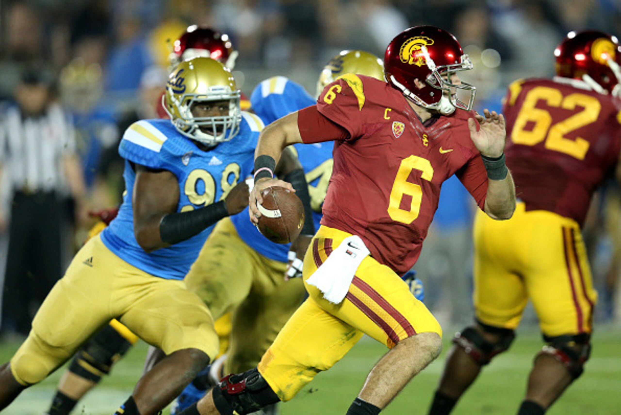 PASADENA, CA - NOVEMBER 22: Quarterback Cody Kessler #6 of the USC Trojans scrambles away from defensive lineman Takkarist McKinley #98 of the UCLA Bruins in the third quarter at the Rose Bowl on November 22, 2014 in Pasadena, California. (Photo by Step PASADENA, CA - NOVEMBER 22: Quarterback Cody Kessler #6 of the USC Trojans scrambles away from defensive lineman Takkarist McKinley #98 of the UCLA Bruins in the third quarter at the Rose Bowl on November 22, 2014 in Pasadena, California. (Photo by Step