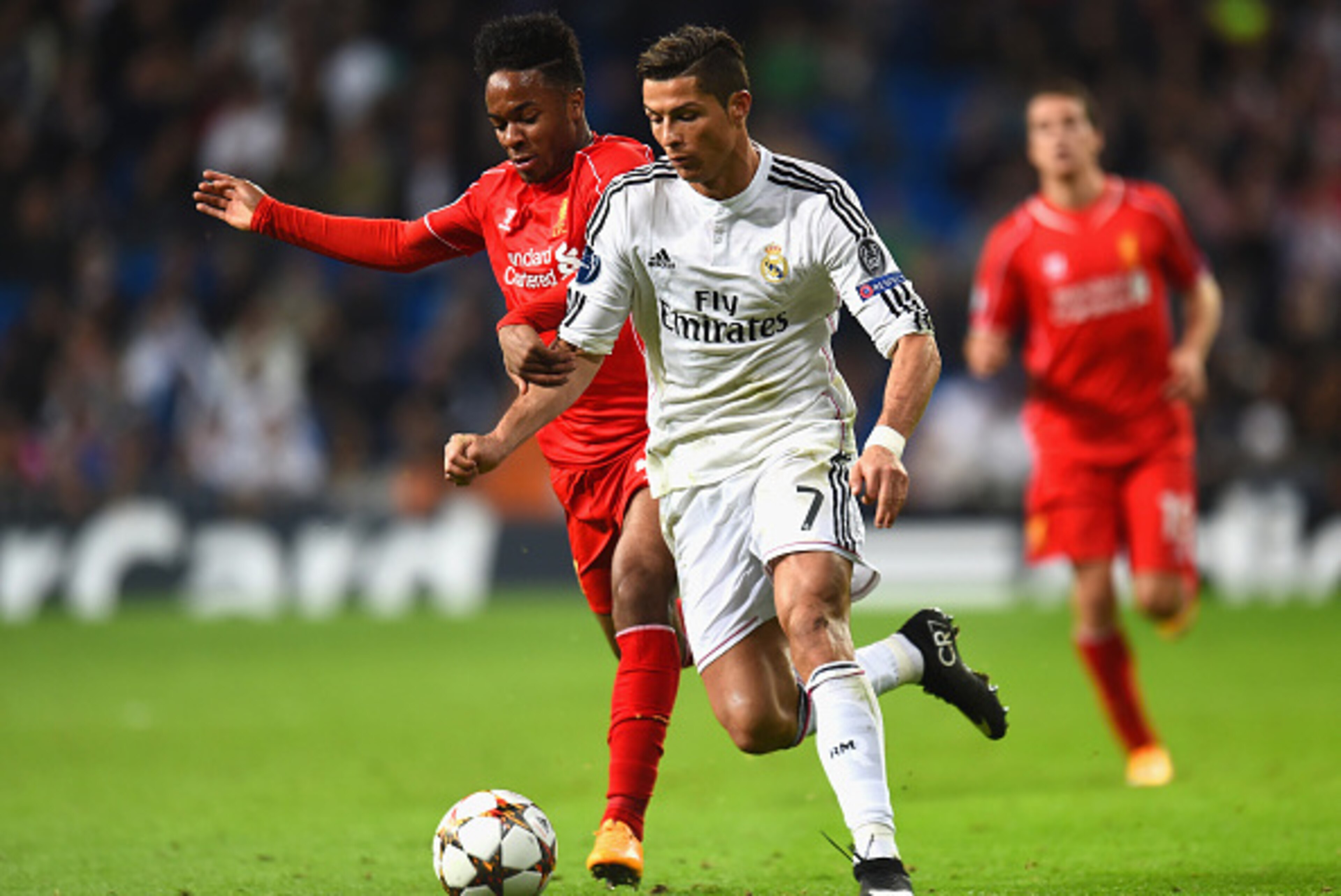 MADRID, SPAIN - NOVEMBER 04:  Raheem Sterling of Liverpool and Cristiano Ronaldo of Real Madrid CF battle for the ball during the UEFA Champions League Group B match between Real Madrid CF and Liverpool FC at Estadio Santiago Bernabeu on November 4, 2014 