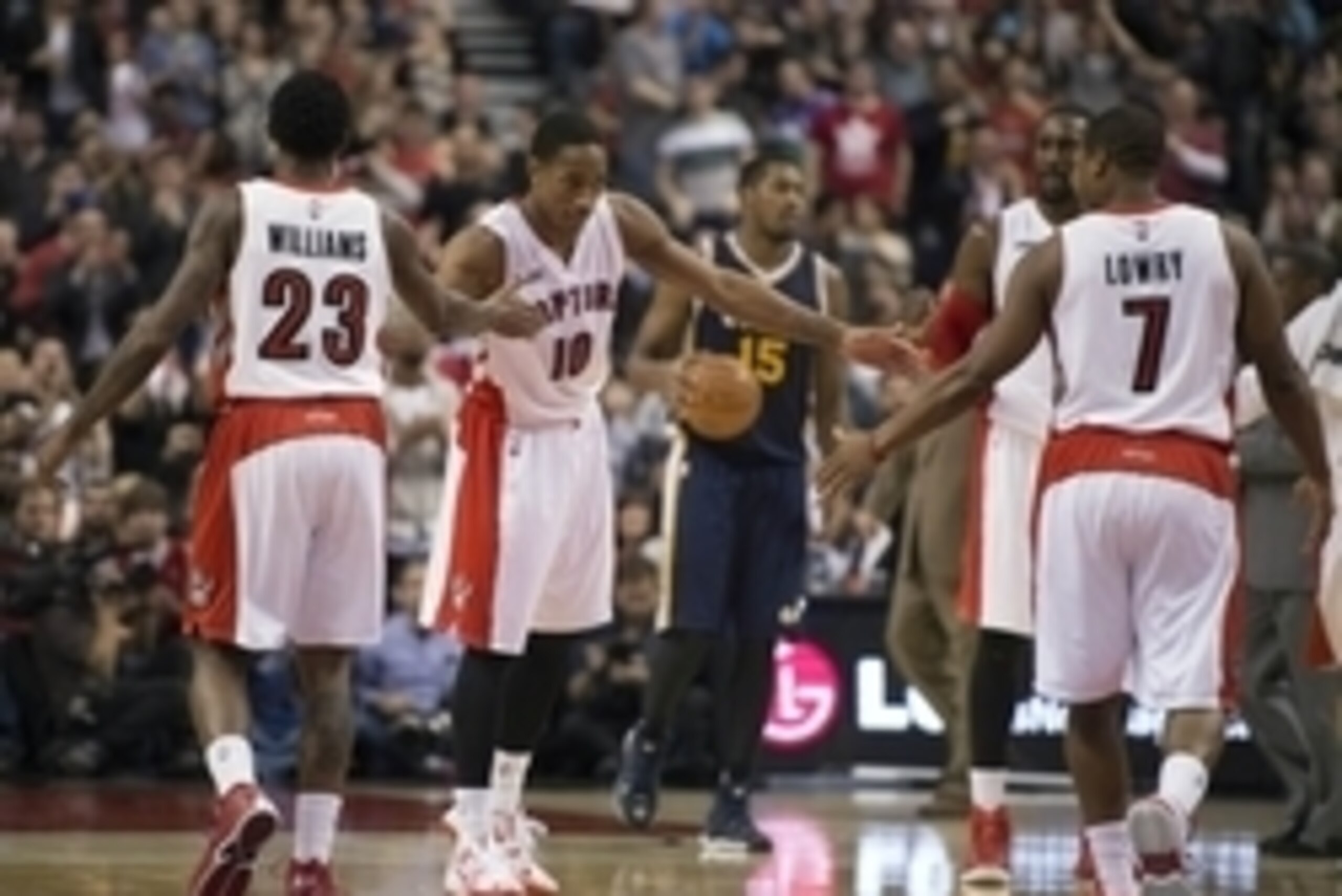 Nov 15, 2014; Toronto, Ontario, CAN; Toronto Raptors guard DeMar DeRozan (10) celebrates with guard Louis Williams (23) and guard Kyle Lowry (7) during the fourth quarter in a game against the Utah Jazz at Air Canada Centre. The Toronto Raptors won 111-93