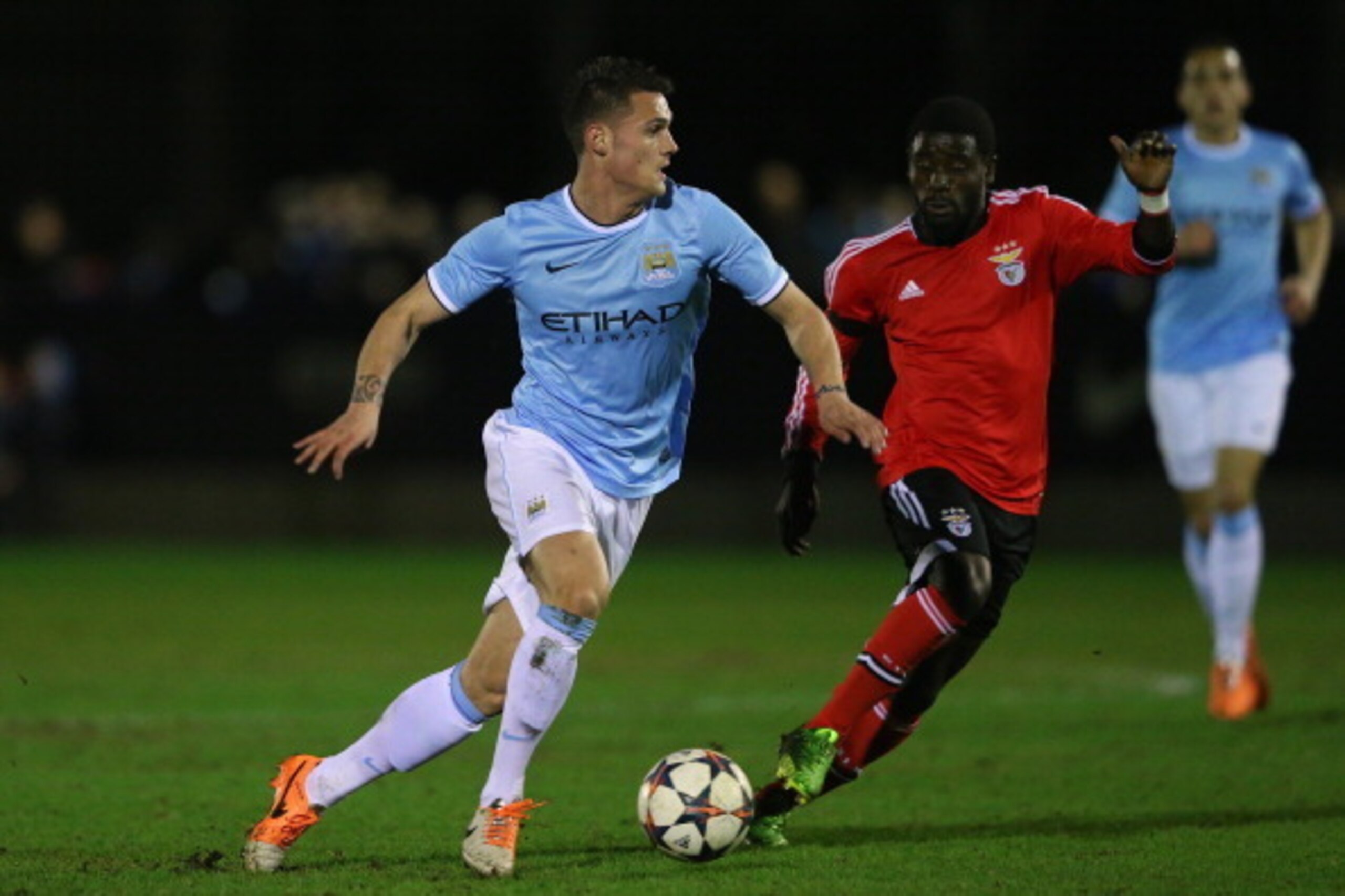 HYDE, ENGLAND - MARCH 18:  Mathias Bossaerts of Manchester City runs at Estrela of SL Benfica during the UEFA Youth League Quarter Final match between Manchester City v SL Benfica at Ewen Fields on March 18, 2014 in Hyde, England.  (Photo by Alex Livesey/