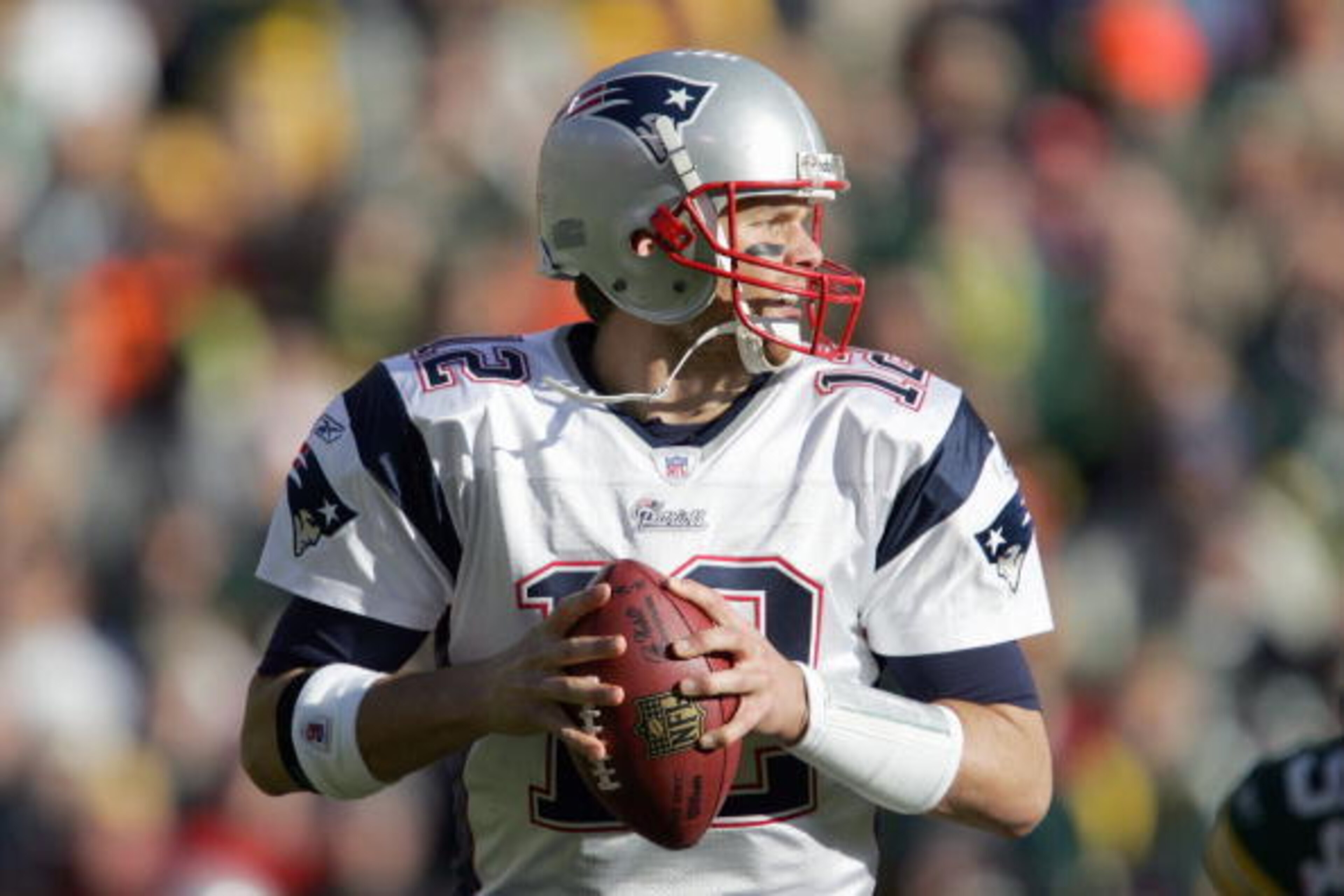 GREEN BAY, WI - NOVEMBER 19: Tom Brady #12 of the New England Patriots looks to pass during the game against the Green Bay Packers on November 19, 2006 at Lambeau Field in Green Bay, Wisconsin. The Patriots defeated the Packers 35-0. (Photo by Jonathan Da
