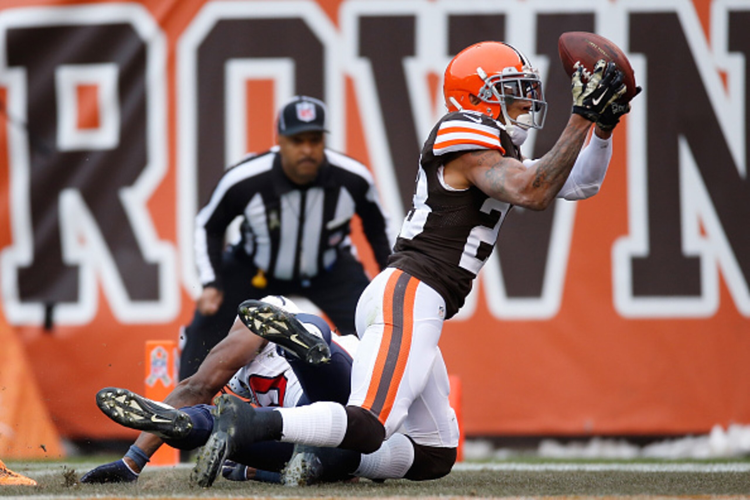 CLEVELAND, OH - NOVEMBER 16:  Joe Haden #23 of the Cleveland Browns intercepts a pass intended or DeAndre Hopkins #10 of the Houston Texans during the first quarter at FirstEnergy Stadium on November 16, 2014 in Cleveland, Ohio.  (Photo by Gregory Shamus/