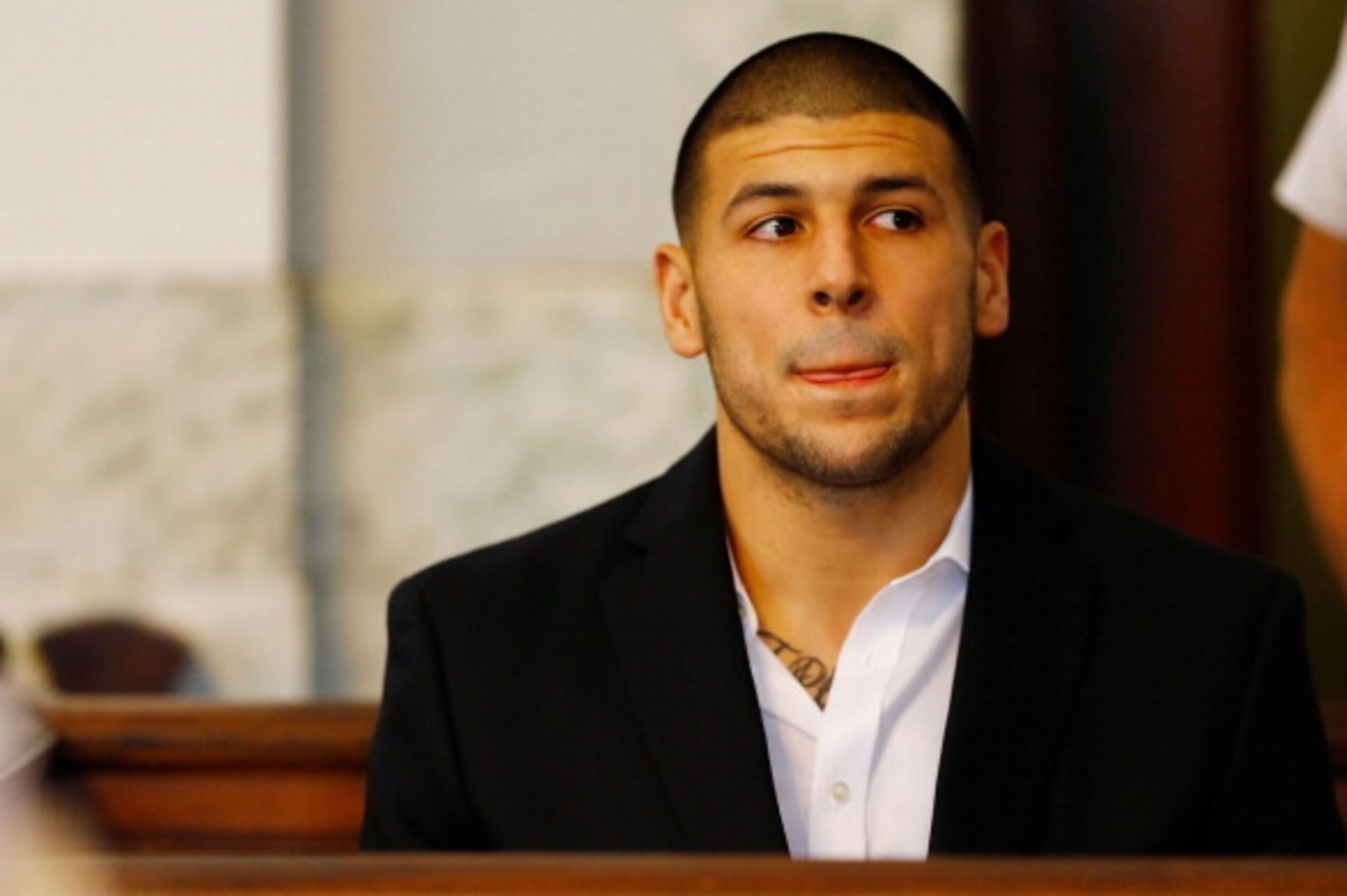 NORTH ATTLEBORO, MA - AUGUST 22: Aaron Hernandez sits in the courtroom of the Attleboro District Court during his hearing on August 22, 2013 in North Attleboro, Massachusetts. Former New England Patriot Aaron Hernandez has been indicted on a first-degree 