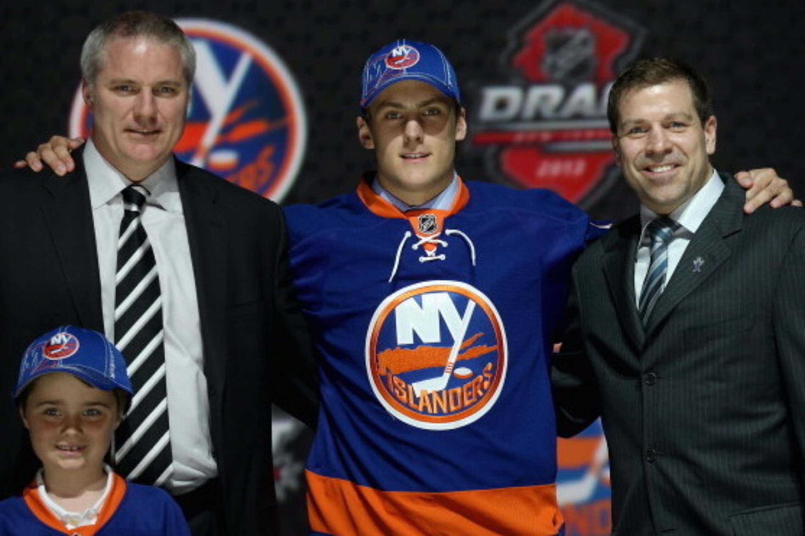 NEWARK, NJ - JUNE 30:  Ryan Pulock (C) poses with General manager Garth Snow (L) and Doug Weight (R) Assistant Coach and Senior Advisor to the General Manager after being selected number fifteen overall in the first round by the New York Islanders during 