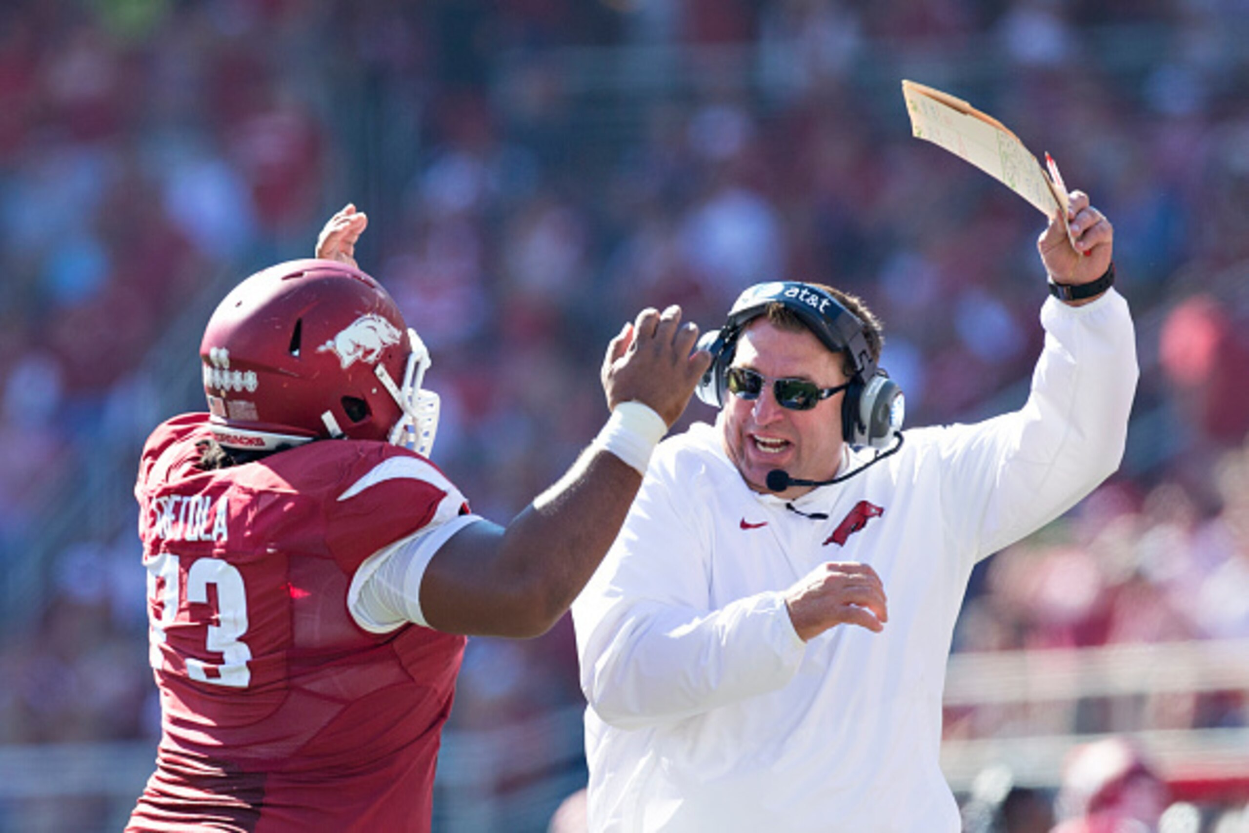 FAYETTEVILLE, AR - OCTOBER 25:  Head Coach Bret Bielema and Sebastian Tretola #73 of the Arkansas Razorbacks celebrate after Tretola throws a touchdown pass against the UAB Blazers at Razorback Stadium on October 25, 2014 in Fayetteville, Arkansas.  (Phot