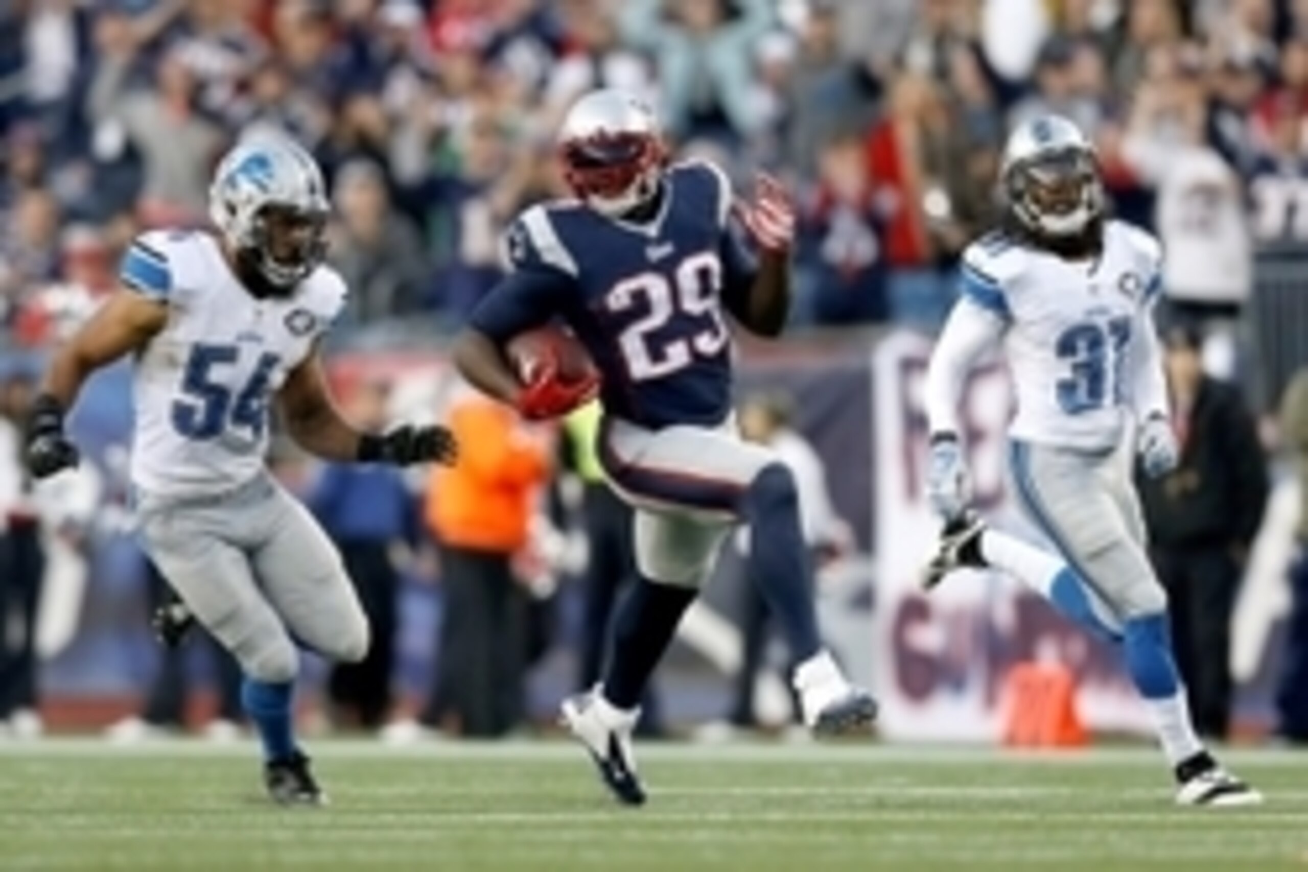 Nov 23, 2014; Foxborough, MA, USA; New England Patriots running back LeGarrette Blount (29) is persued by Detroit Lions linebacker DeAndre Levy (54) and cornerback Rashean Mathis (31) during the fourth quarter at Gillette Stadium.  The New England Patriot