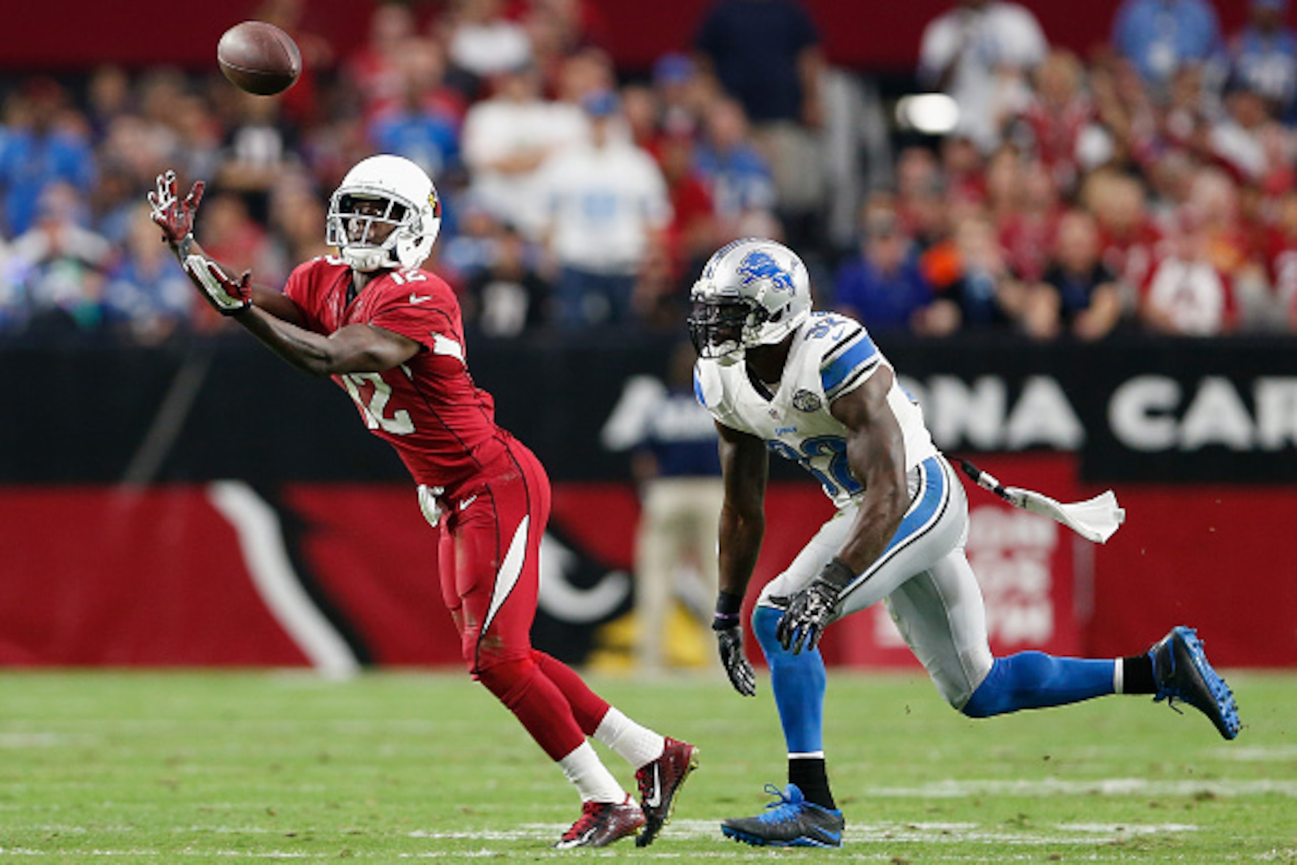 GLENDALE, AZ - NOVEMBER 16:  Wide receiver John Brown #12 of the Arizona Cardinals catches the football against strong safety James Ihedigbo #32 of the Detroit Lions in the third quarter during the NFL game at the University of Phoenix Stadium on November