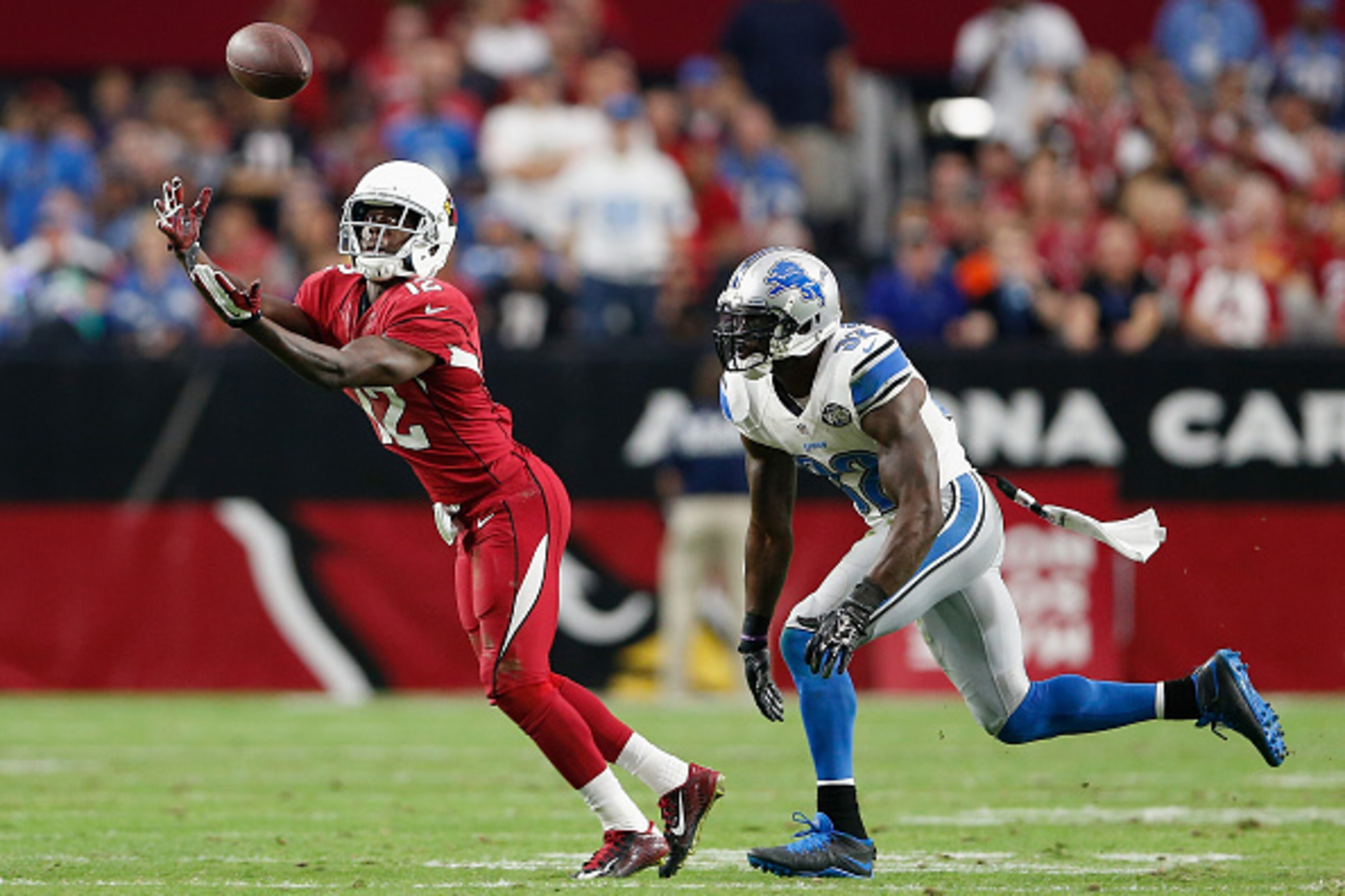 GLENDALE, AZ - NOVEMBER 16:  Wide receiver John Brown #12 of the Arizona Cardinals catches the football against strong safety James Ihedigbo #32 of the Detroit Lions in the third quarter during the NFL game at the University of Phoenix Stadium on November