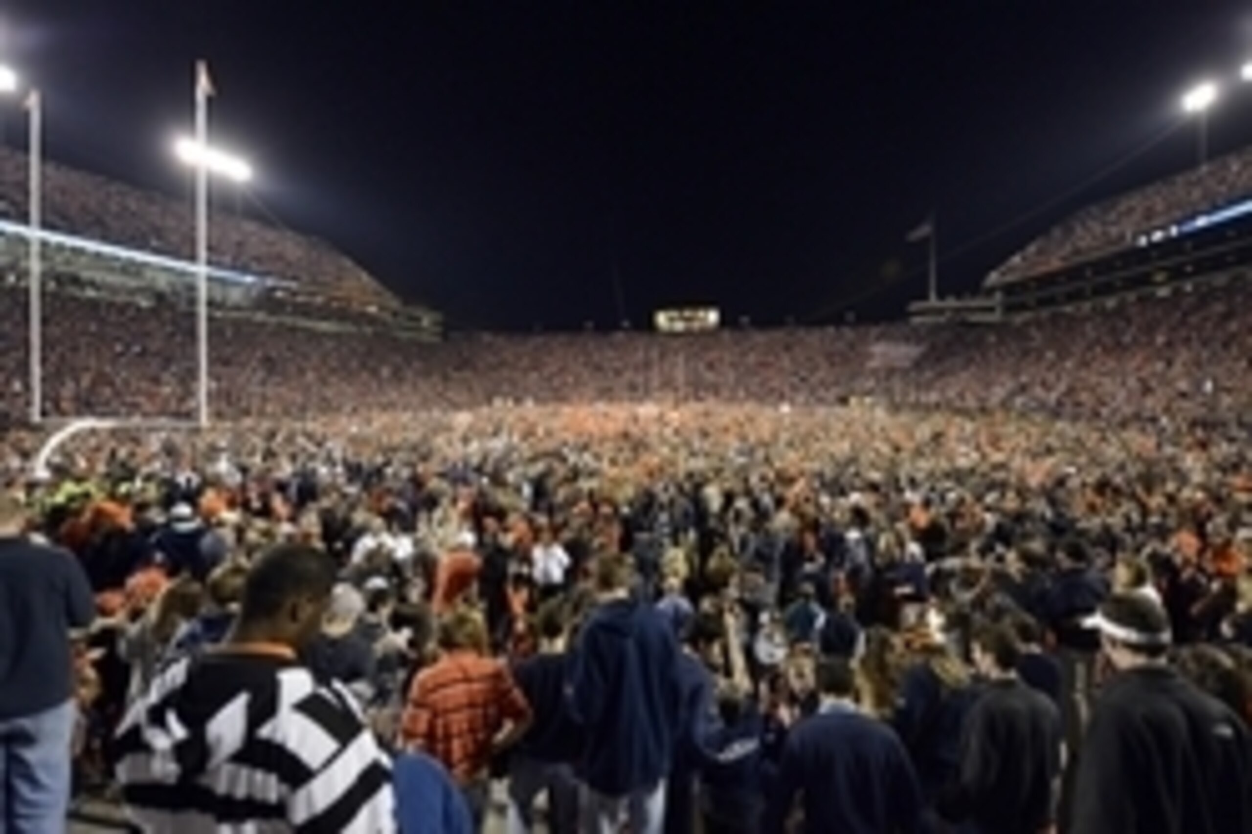 Nov 30, 2013; Auburn, AL, USA;  Auburn Tigers fans storm the field in celebration following their victory over the Alabama Crimson Tide 34-28 after a 100 yard return of a missed field goal by  cornerback Chris Davis (11) with no time left in the game at J