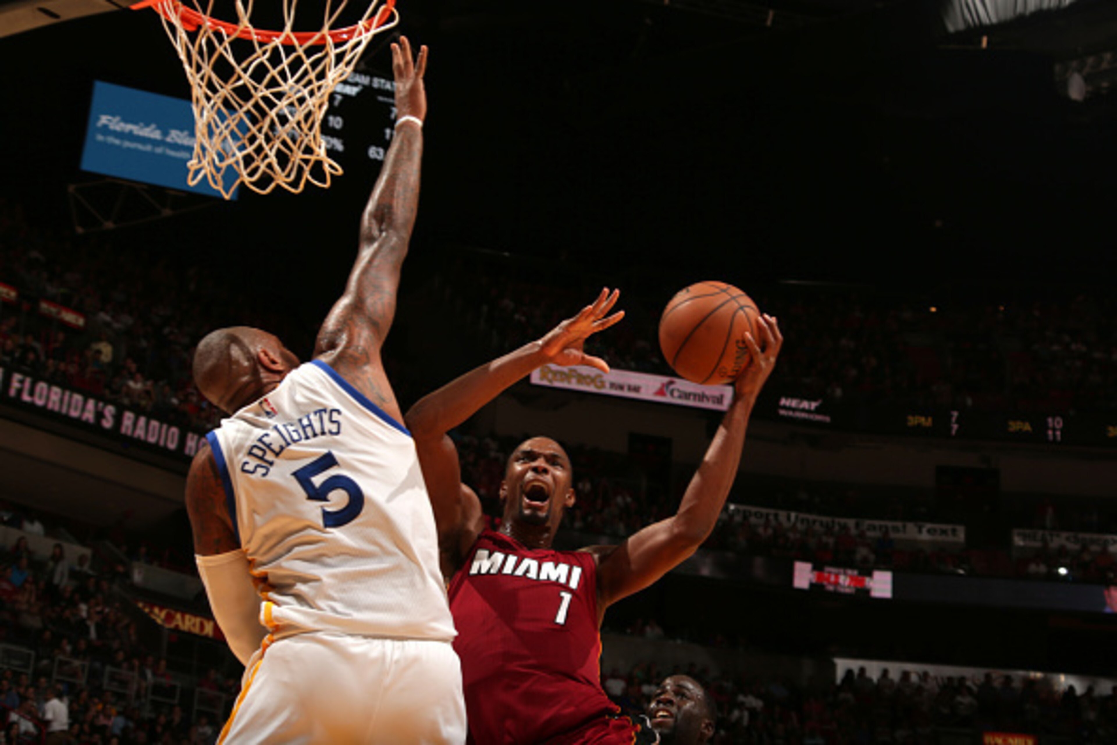 MIAMI, FL - NOVEMBER 25: Chris Bosh #1 of the Miami Heat goes to the basket against Marreese Speights #5 of the Golden State Warriors on November 25, 2014 at American Airlines Arena in Miami, Florida. NOTE TO USER: User expressly acknowledges and agrees MIAMI, FL - NOVEMBER 25: Chris Bosh #1 of the Miami Heat goes to the basket against Marreese Speights #5 of the Golden State Warriors on November 25, 2014 at American Airlines Arena in Miami, Florida. NOTE TO USER: User expressly acknowledges and agrees