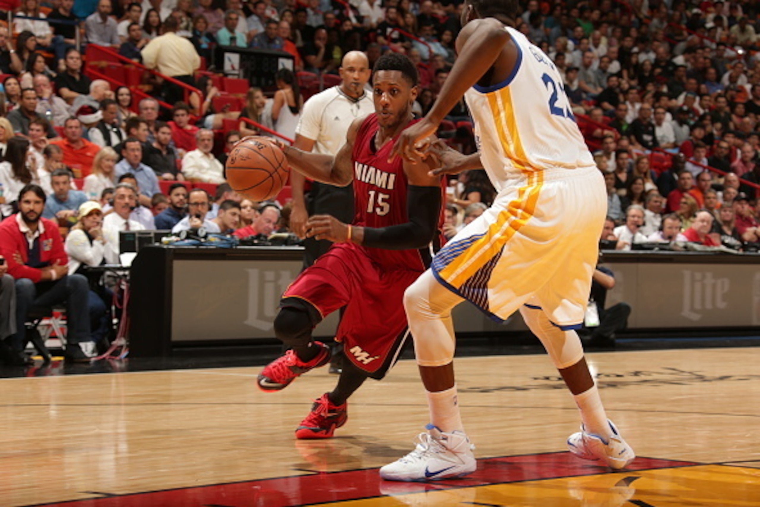 MIAMI, FL - NOVEMBER 25:  Mario Chalmers #15 of the Miami Heat drives to the basket against the Golden State Warriors on November 25, 2014 at American Airlines Arena in Miami, Florida.  NOTE TO USER: User expressly acknowledges and agrees that, by downloa