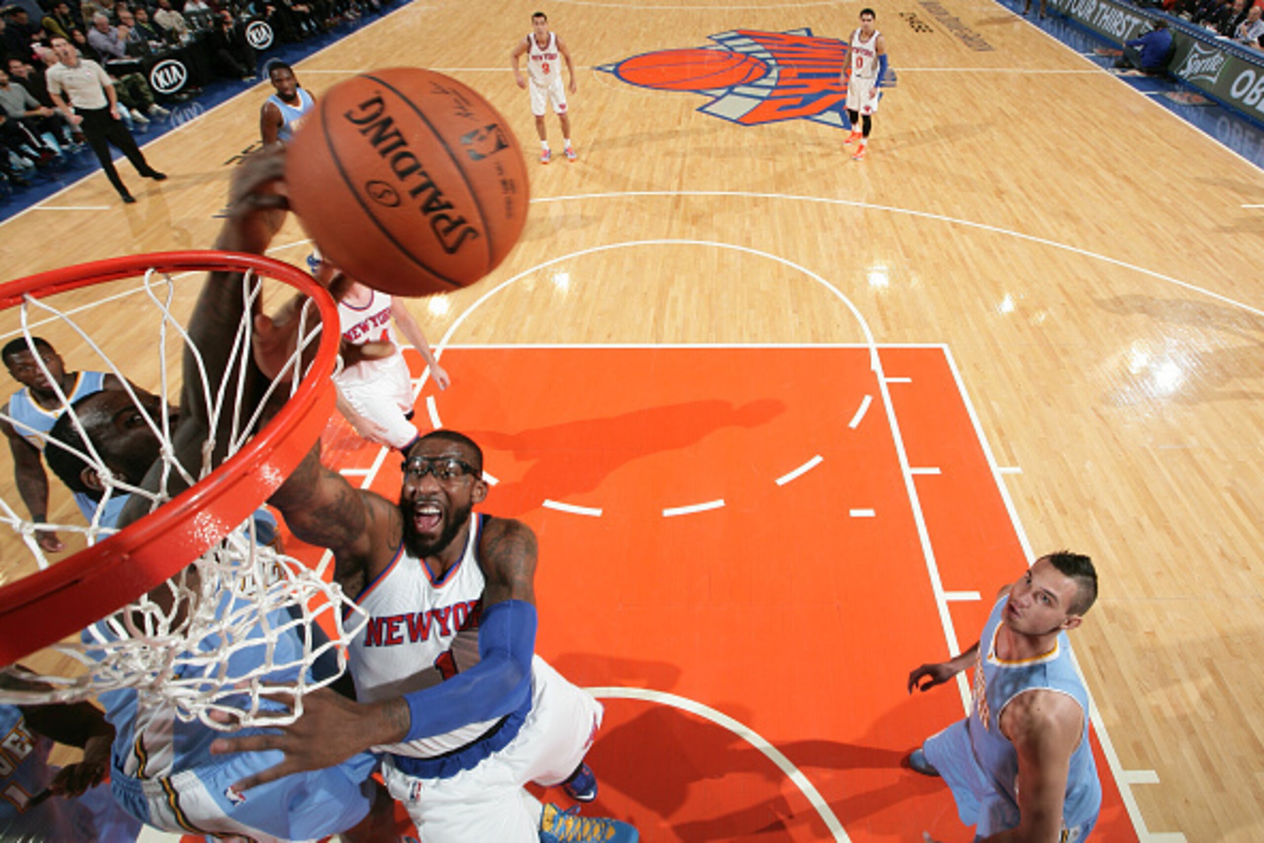 NEW YORK, NY - NOVEMBER 16:  J.J. Hickson #7 of the Denver Nuggets blocks the shot of Amar'e Stoudemire #1 of the New York Knicks during the game at Madison Square Garden in New York City, New York on November 16, 2014.  NOTE TO USER: User expressly ackno