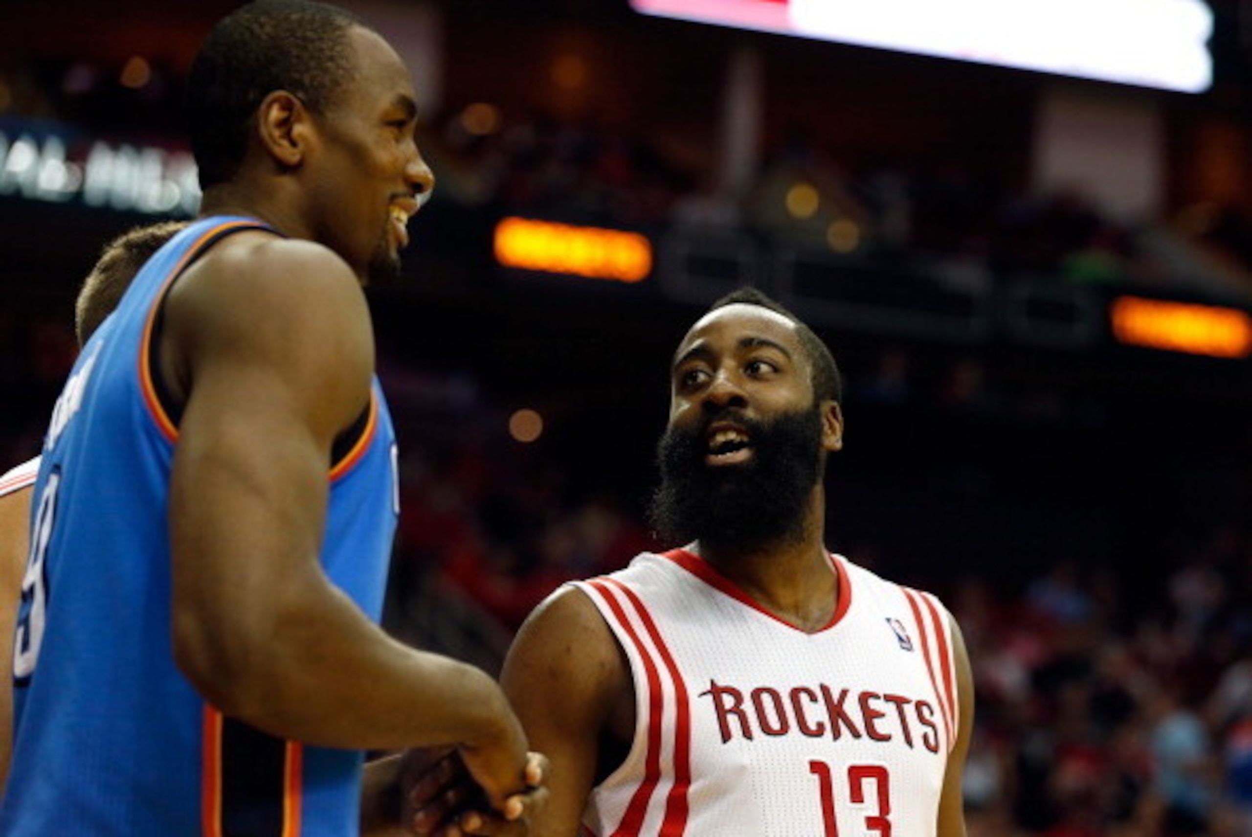 HOUSTON, TX - APRIL 04:  James Harden #13 of the Houston Rockets talks with Serge Ibaka #9 of the Oklahoma City Thunder during a game at the Toyota Center on April 4, 2014 in Houston, Texas. NOTE TO USER: User expressly acknowledges and agrees that, by do