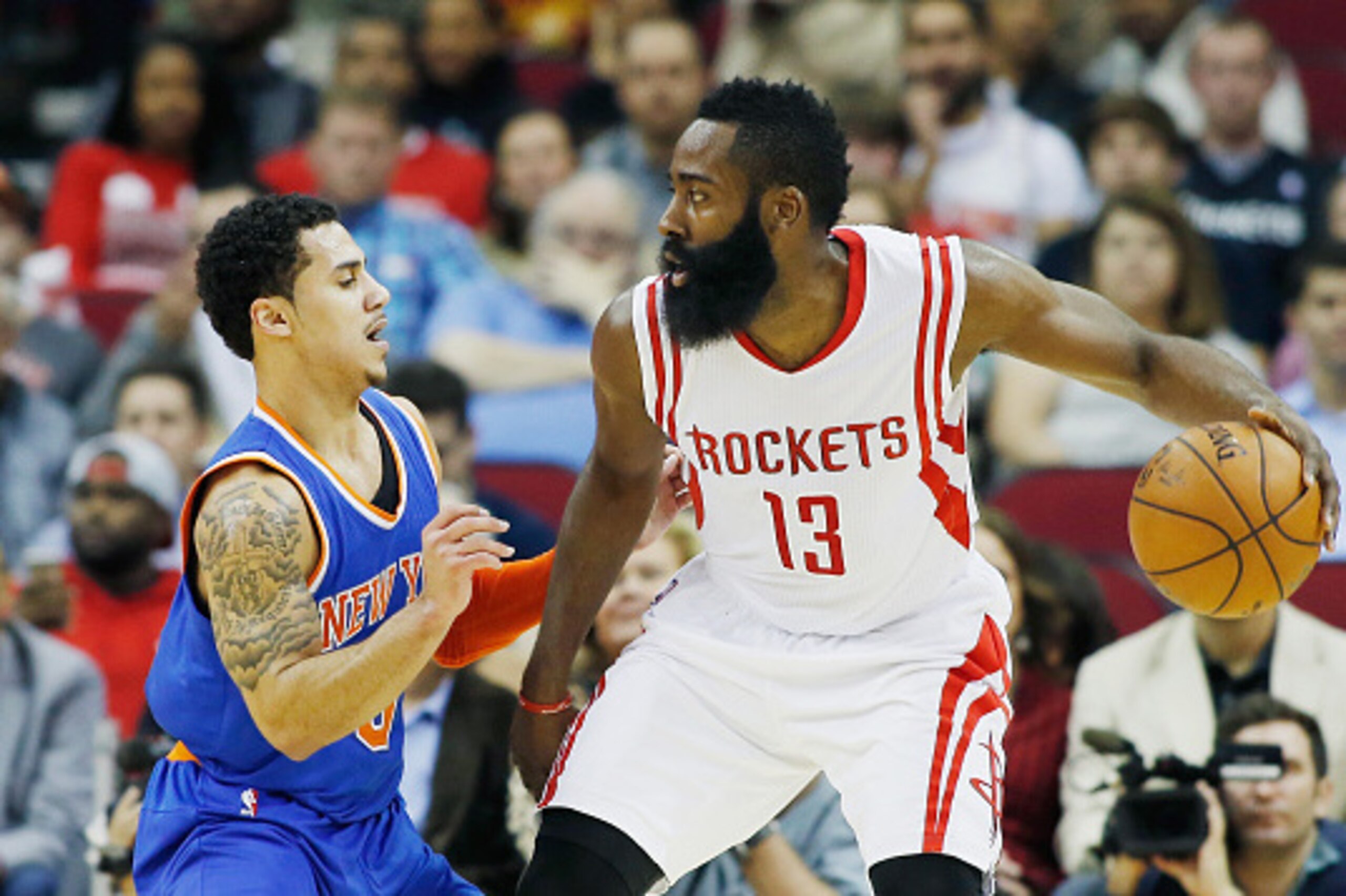 HOUSTON, TX - NOVEMBER 24:  James Harden #13 of the Houston Rockets drives with the ball against Shane Larkin #0 of the New York Knicks during their game at the Toyota Center on November 24, 2014 in Houston, Texas.  NOTE TO USER: User expressly acknowledg