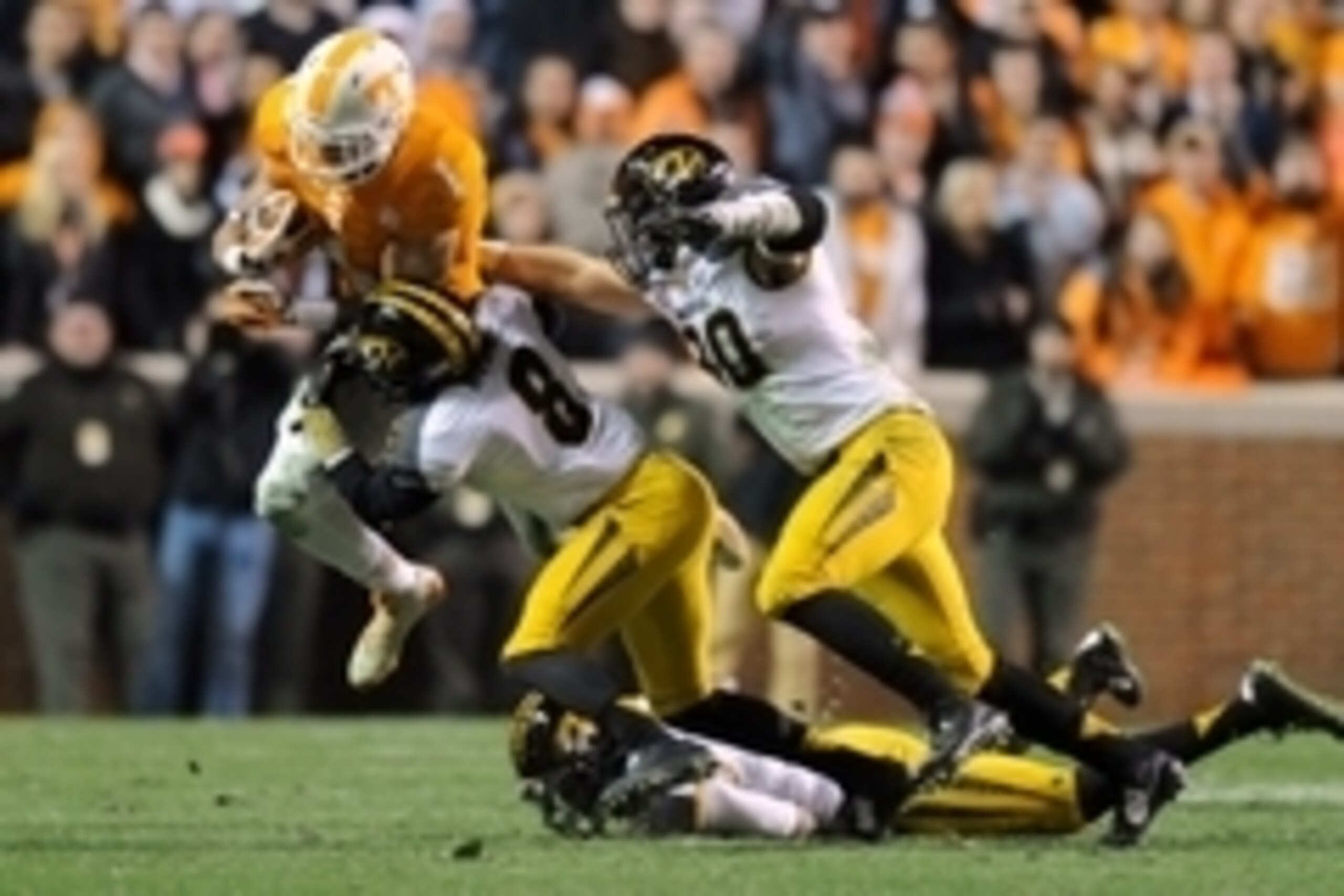 Nov 22, 2014; Knoxville, TN, USA;  Missouri Tigers safety Thomas Wilson (8) tackles Tennessee Volunteers running back Jalen Hurd (1) during the second half at Neyland Stadium. Missouri won 29 to 21. Mandatory Credit: Randy Sartin-USA TODAY Sports