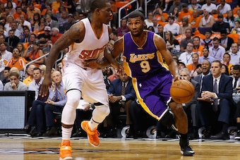 PHOENIX, AZ - OCTOBER 29:  Ronnie Price #9 of the Los Angeles Lakers handles the ball against Eric Bledsoe #2 of the Phoenix Suns during the NBA game at US Airways Center on October 29, 2014 in Phoenix, Arizona. The Suns defeated the Lakers 119-99. NOTE T