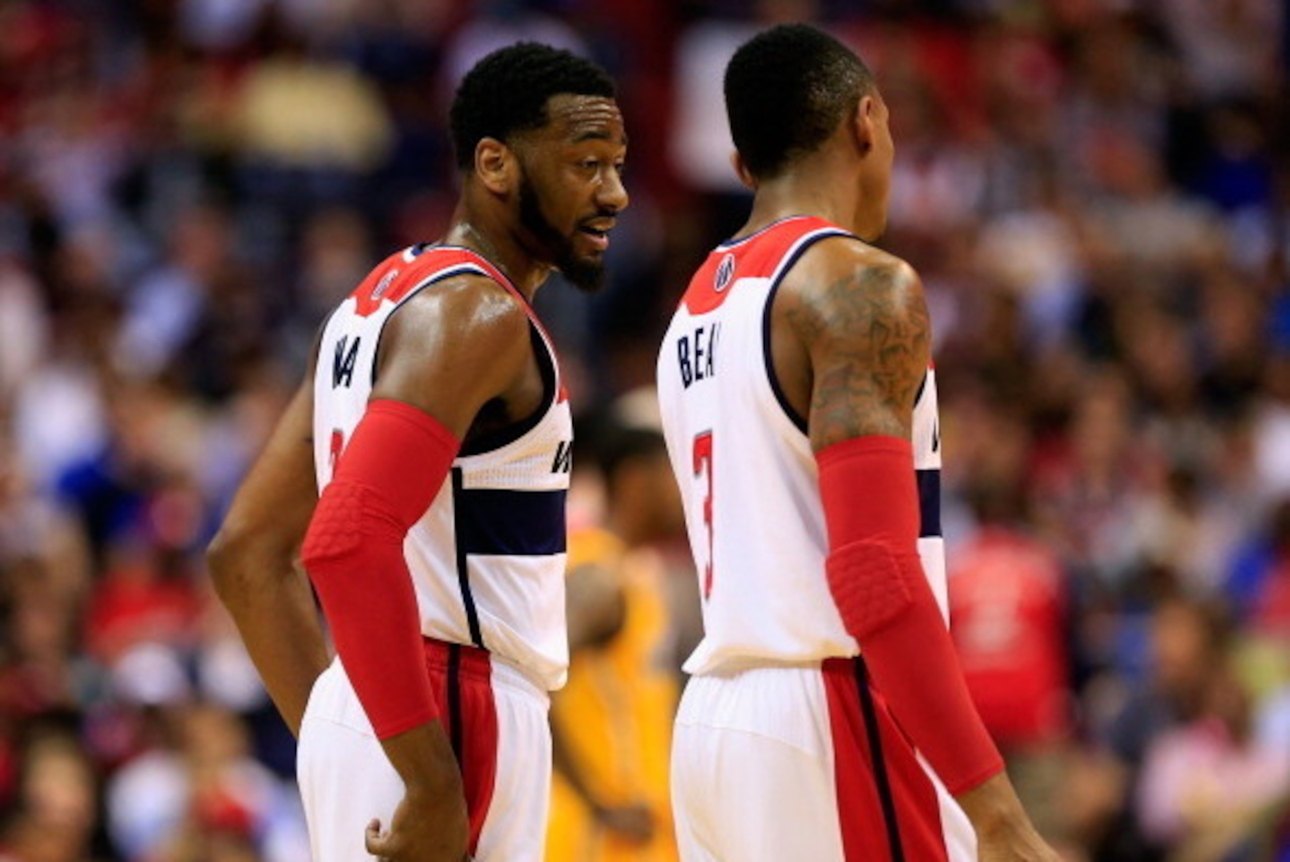 WASHINGTON, DC - MAY 09: John Wall #2 of the Washington Wizards talks with teammate Bradley Beal #3 during the first of half against the Indiana Pacers during Game 3 of the Eastern Conference Semifinals during the 2014 NBA Playoffs at Verizon Center on Ma