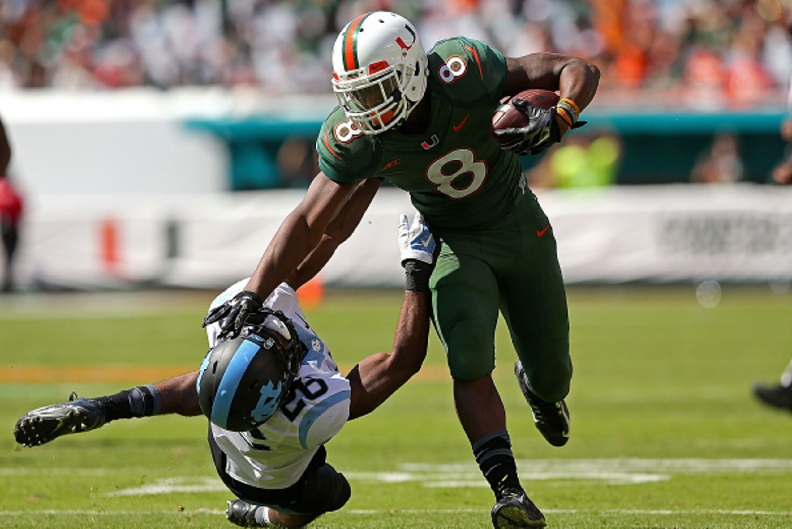 MIAMI GARDENS, FL - NOVEMBER 01:  Duke Johnson #8 of the Miami Hurricanes rushes for a first down during a game against the North Carolina Tar Heels at Sun Life Stadium on November 1, 2014 in Miami Gardens, Florida.  (Photo by Mike Ehrmann/Getty Images)
