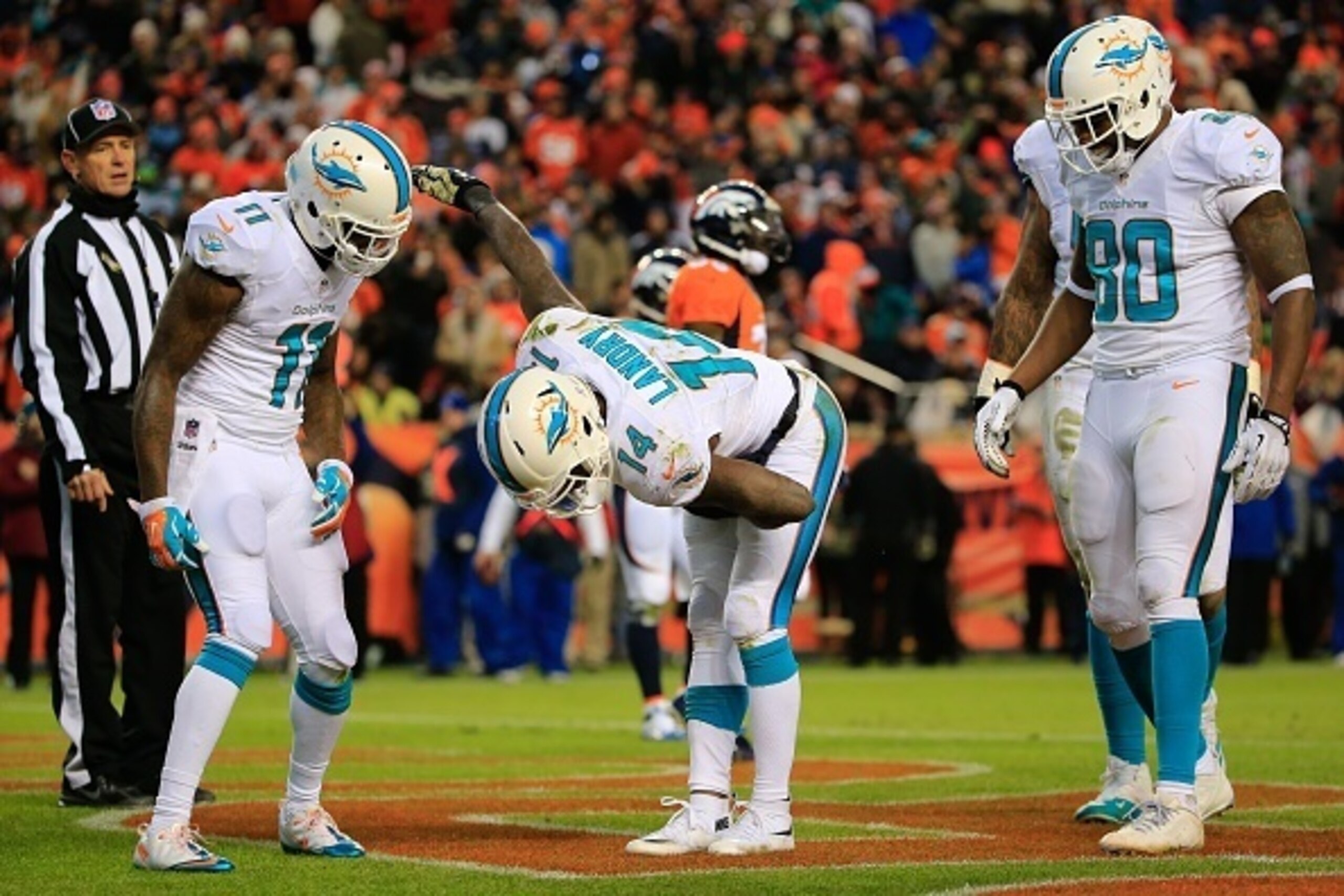 DENVER, CO - NOVEMBER 23: Wide receiver Jarvis Landry #14 of the Miami Dolphins celebrates a third quarter touchdown against the Denver Broncos during a game at Sports Authority Field at Mile High on November 23, 2014 in Denver, Colorado. (Photo by Doug DENVER, CO - NOVEMBER 23: Wide receiver Jarvis Landry #14 of the Miami Dolphins celebrates a third quarter touchdown against the Denver Broncos during a game at Sports Authority Field at Mile High on November 23, 2014 in Denver, Colorado. (Photo by Doug