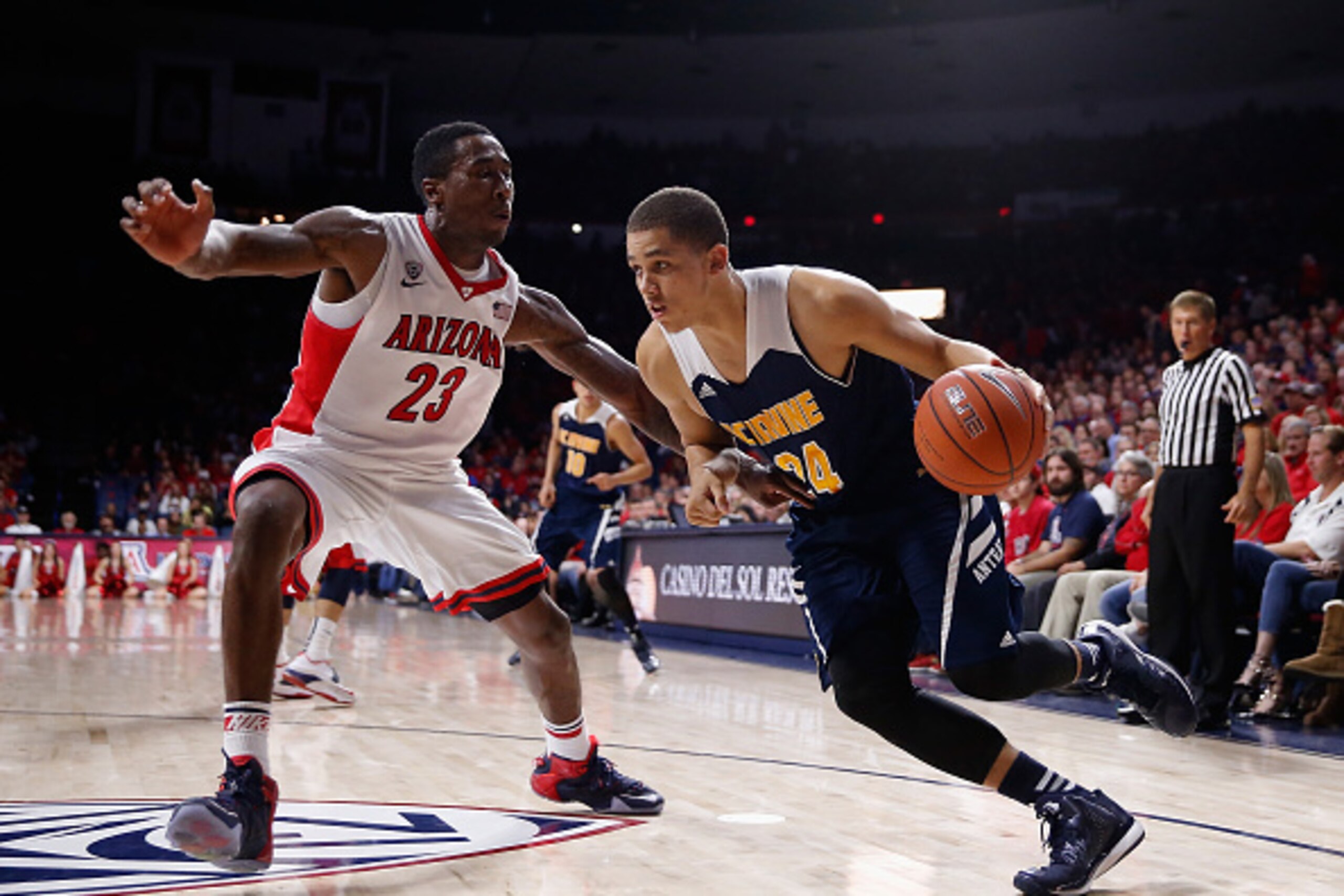 TUCSON, AZ - NOVEMBER 19:  Dominique Dunning #24 of the UC Irvine Anteaters drives the ball past Rondae Hollis-Jefferson #23 of the Arizona Wildcats during the college basketball game at McKale Center on November 19, 2014 in Tucson, Arizona. The Wildcats 