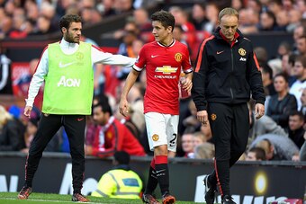 MANCHESTER, ENGLAND - SEPTEMBER 27:  Ander Herrera of Manchester United is consoled by teammate Juan Mata of Manchester United after being substituted in the second half during the Barclays Premier League match between Manchester United and West Ham Unite