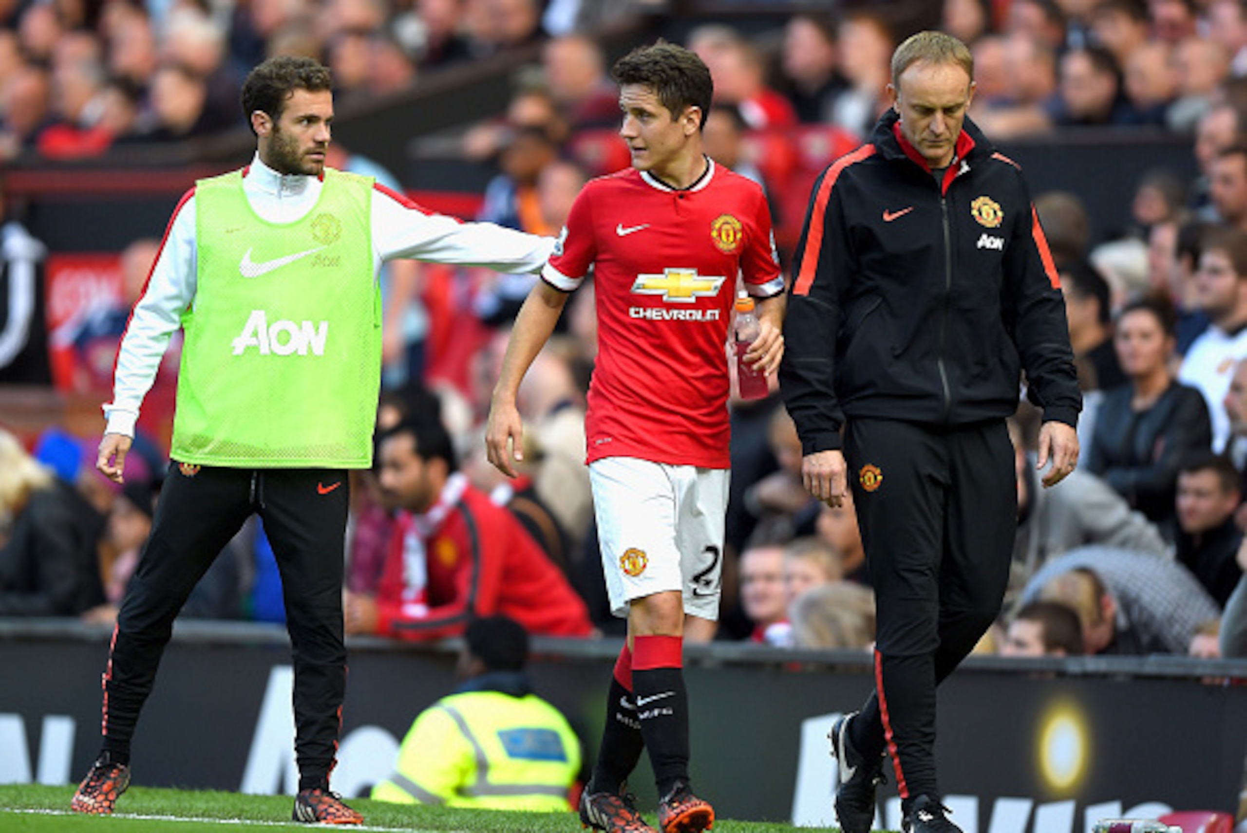 MANCHESTER, ENGLAND - SEPTEMBER 27:  Ander Herrera of Manchester United is consoled by teammate Juan Mata of Manchester United after being substituted in the second half during the Barclays Premier League match between Manchester United and West Ham Unite
