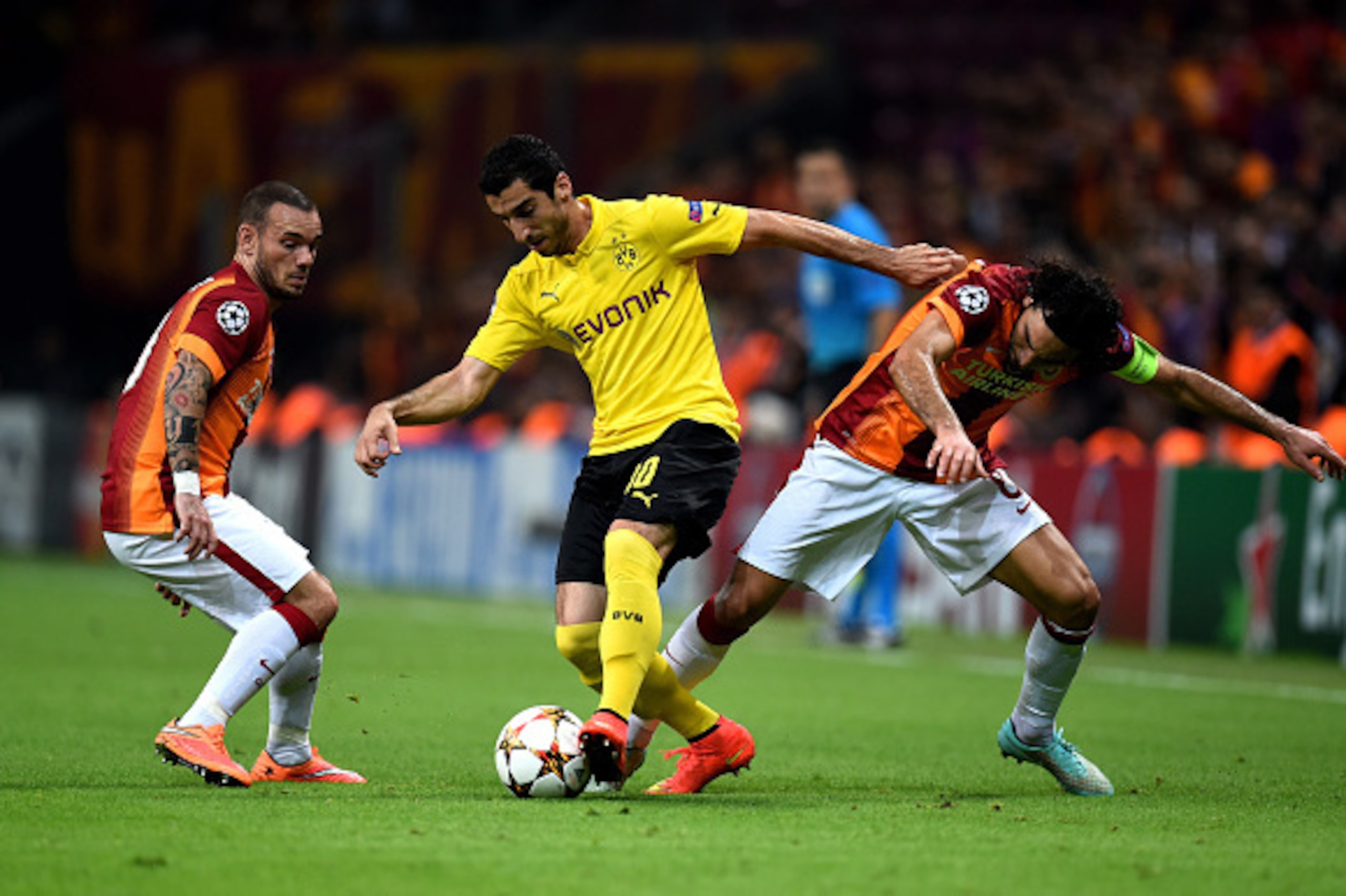 ISTANBUL, TURKEY - OCTOBER 22:  Henrikh Mkhitaryan of Borussia Dortmund is challenged by Selcuk Inan of Galatasaray during UEFA Champions League Group D match between Galatasaray and Borussia Dortmund at Turk Telekom Arena on October 22, 2014 in Istanbul,
