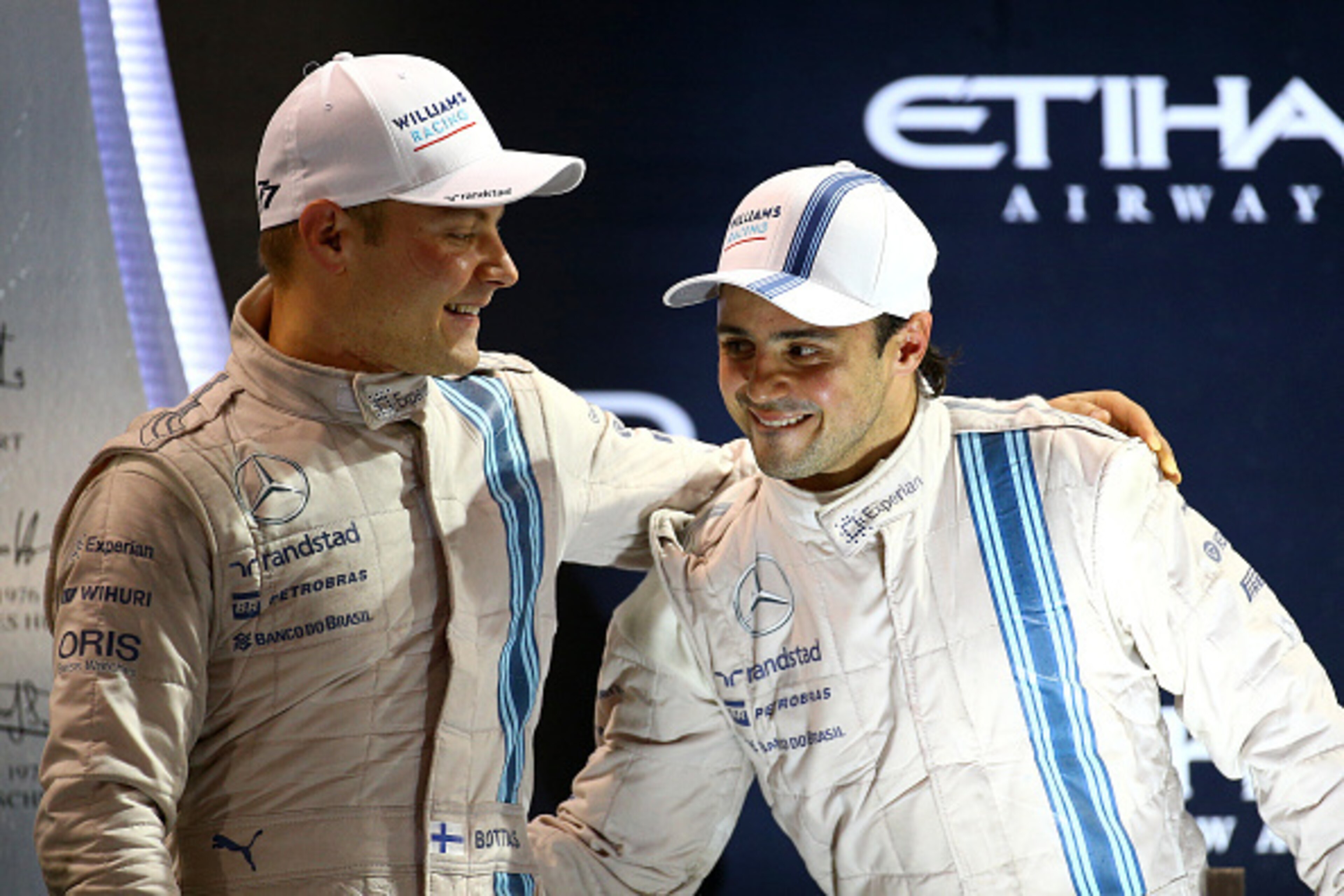 ABU DHABI, UNITED ARAB EMIRATES - NOVEMBER 23:  Valtteri Bottas of Finland and Williams celebrates on the podium with Felipe Massa of Brazil and Williams after finisihing third and second respectively in the Abu Dhabi Formula One Grand Prix at Yas Marina 