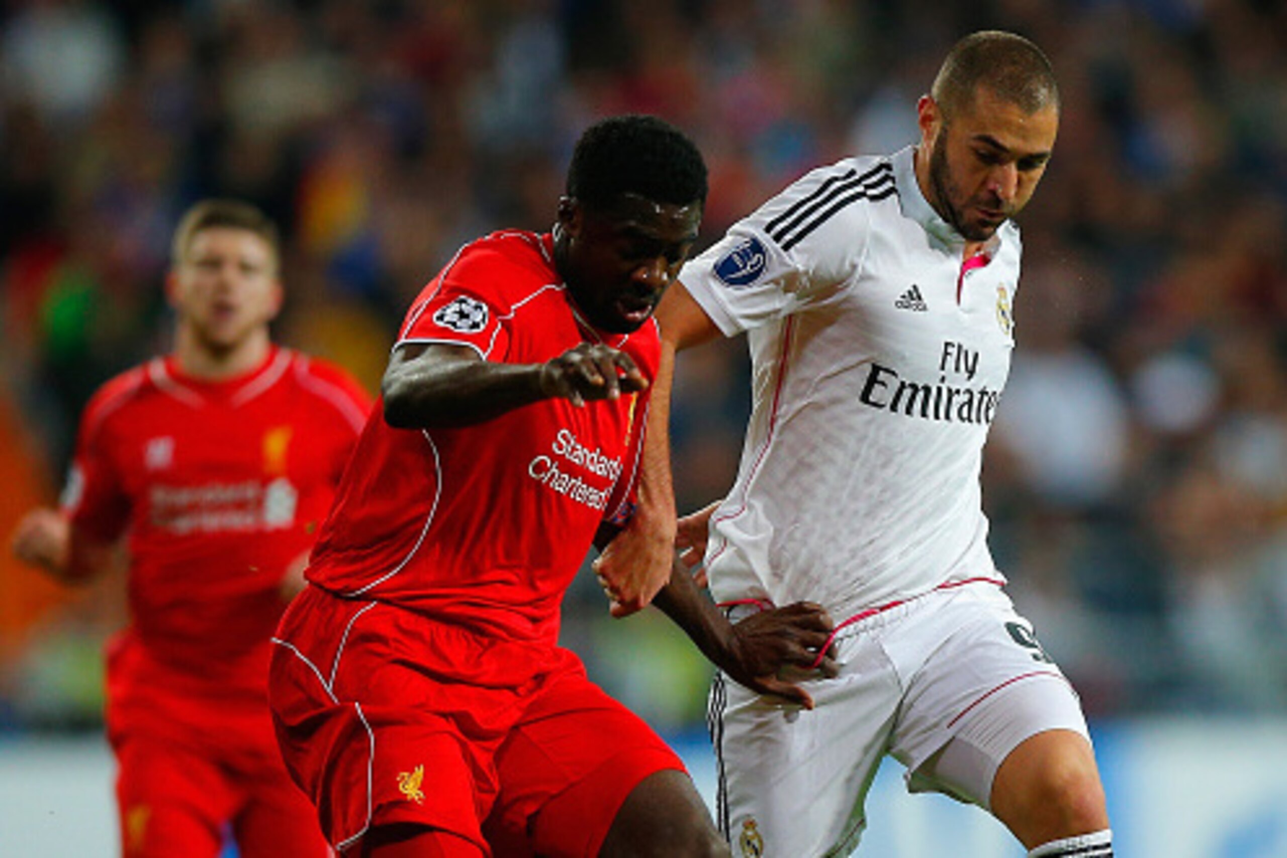 MADRID, SPAIN - NOVEMBER 04: Kolo Toure of Liverpool and Karim Benzema of Real Madrid CF battle for the ball during the UEFA Champions League Group B match between Real Madrid CF and Liverpool FC at Estadio Santiago Bernabeu on November 4, 2014 in Madrid,