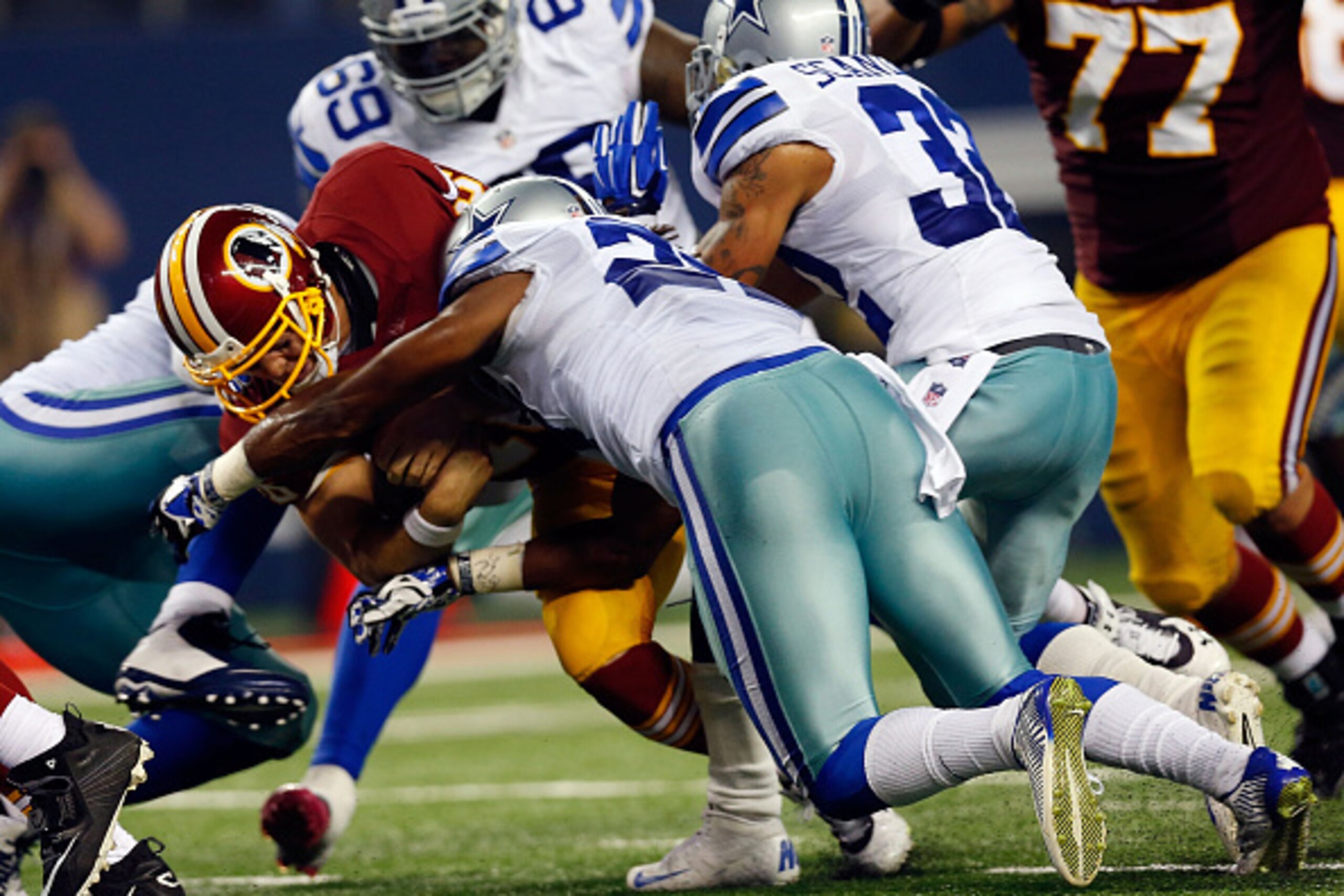 ARLINGTON, TX - OCTOBER 27:  Orlando Scandrick #32 of the Dallas Cowboys is unable to stop Colt McCoy #16 of the Washington Redskins from running for a touchdown during the second half at AT&T Stadium on October 27, 2014 in Arlington, Texas.  (Photo by To